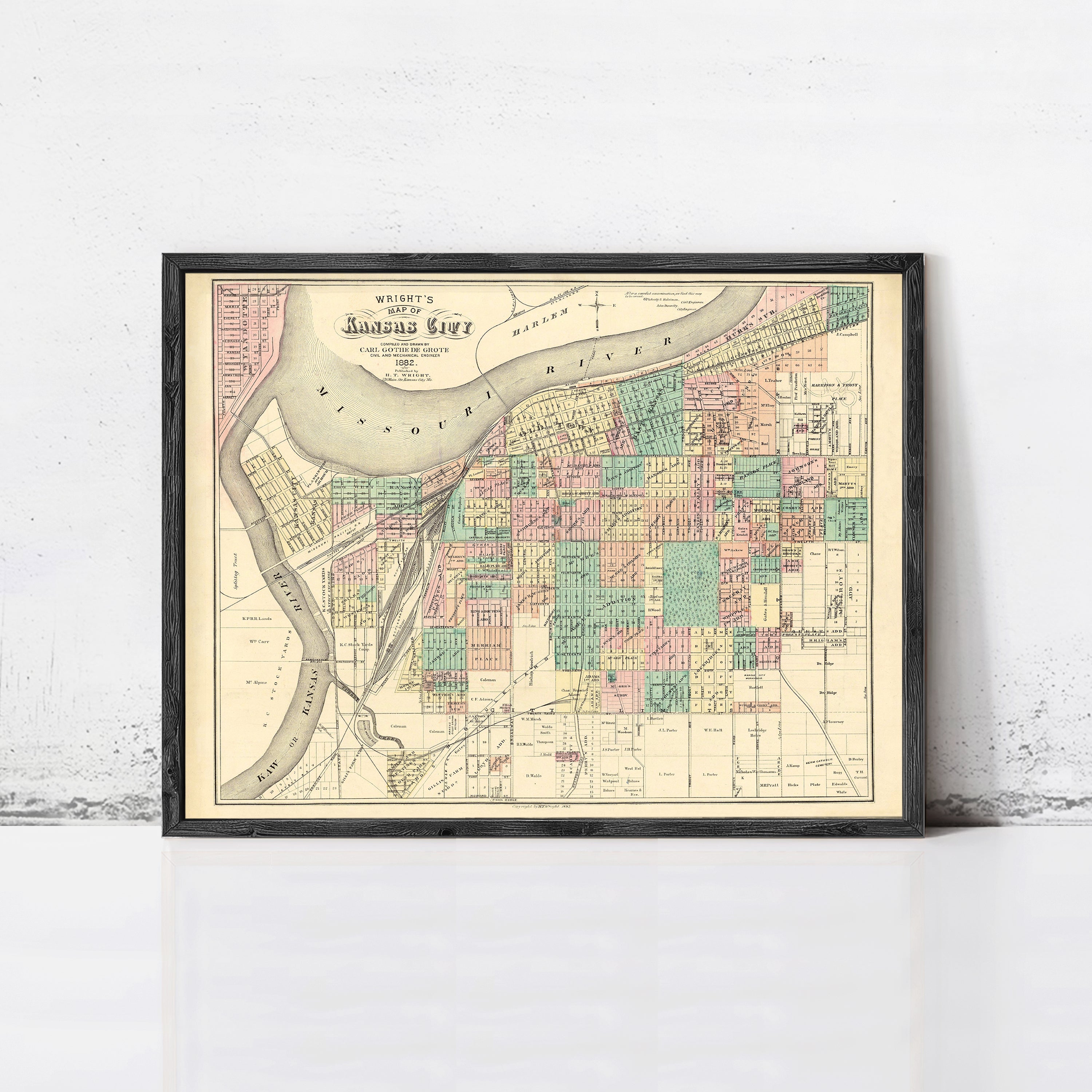 The image is a framed vintage map of the Kansas City area, depicting the city's layout and surrounding regions.