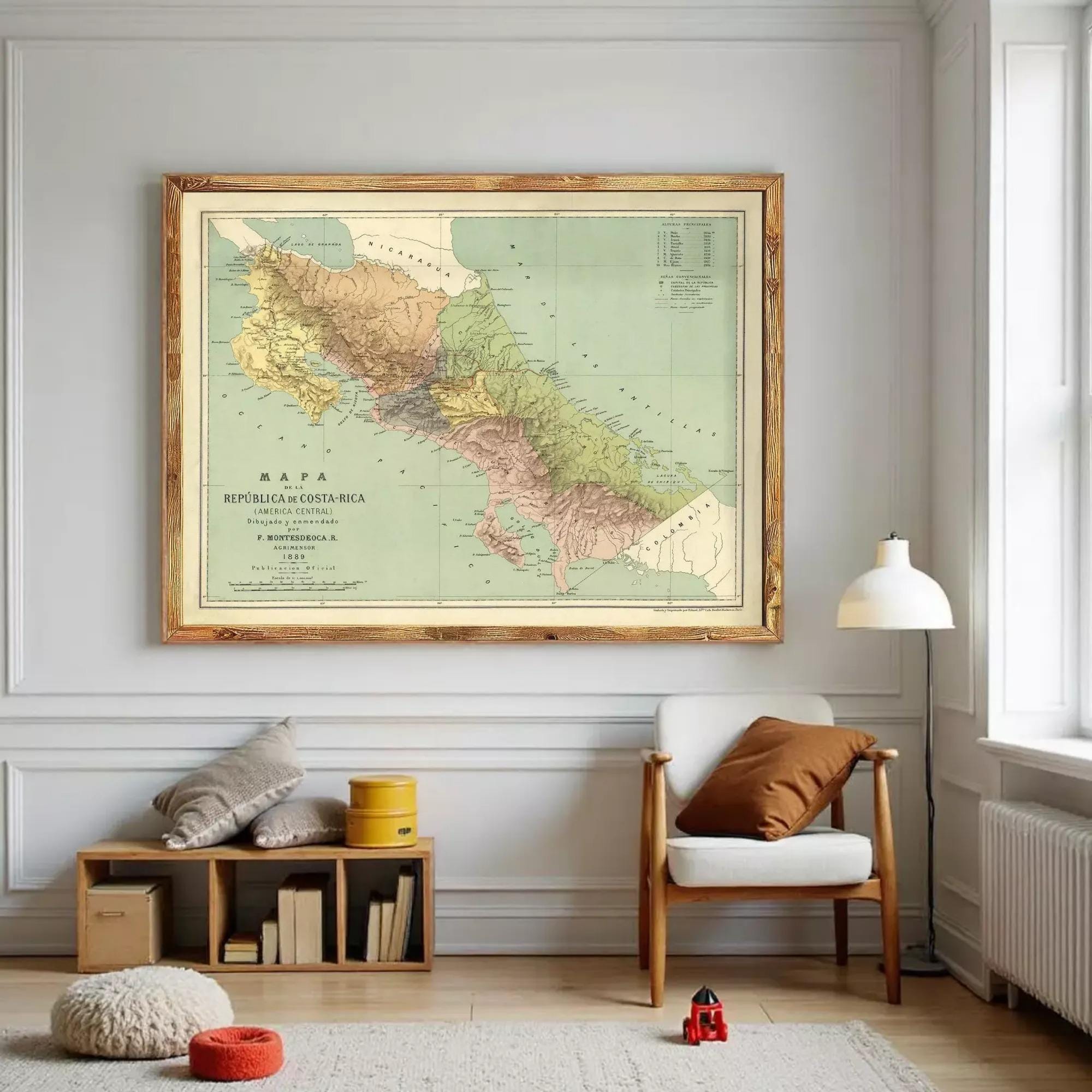 a large framed map of Costa Rica hanging on a wall in a living room.