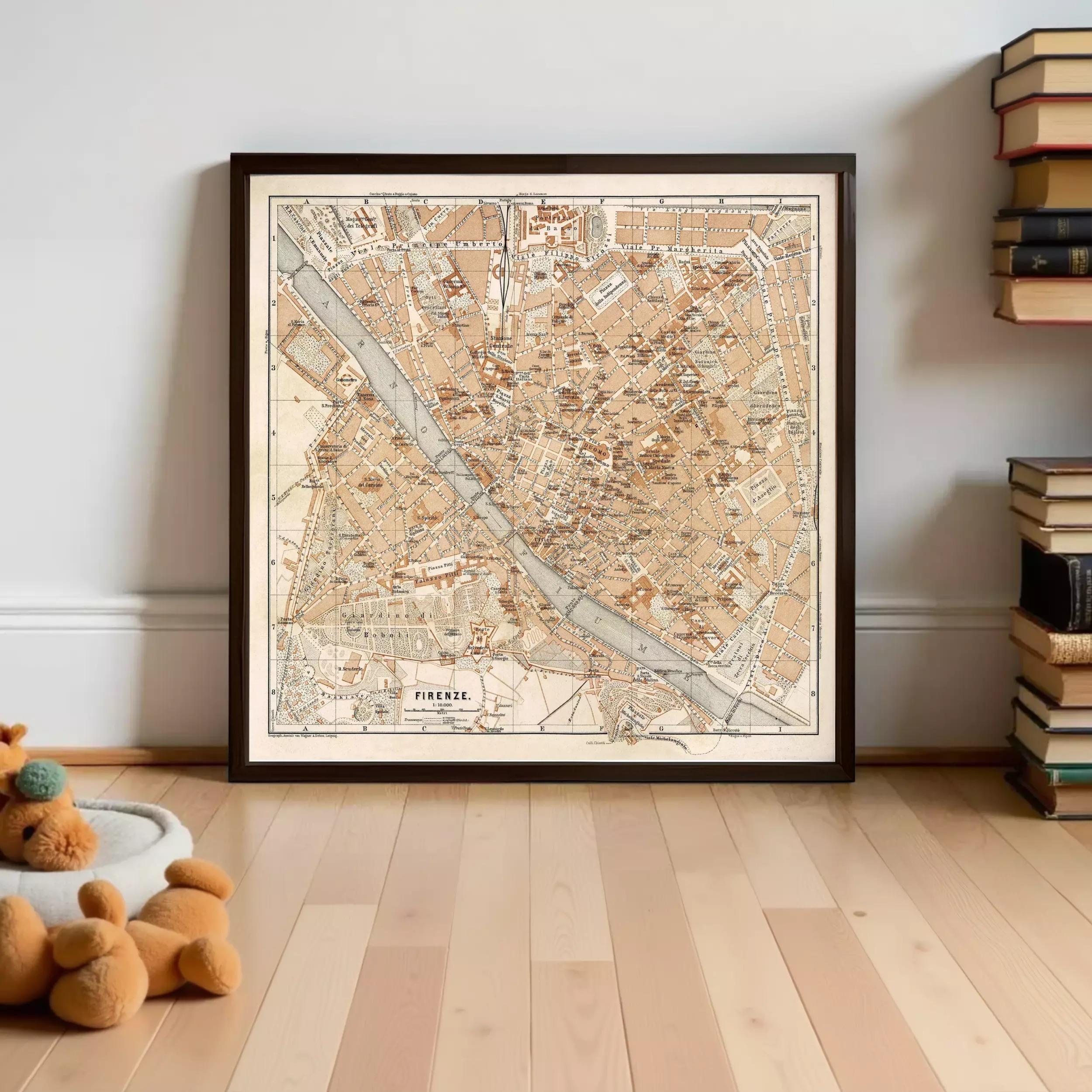 A framed map of Florence, Italy, displayed on a wall in a room with a wooden floor.