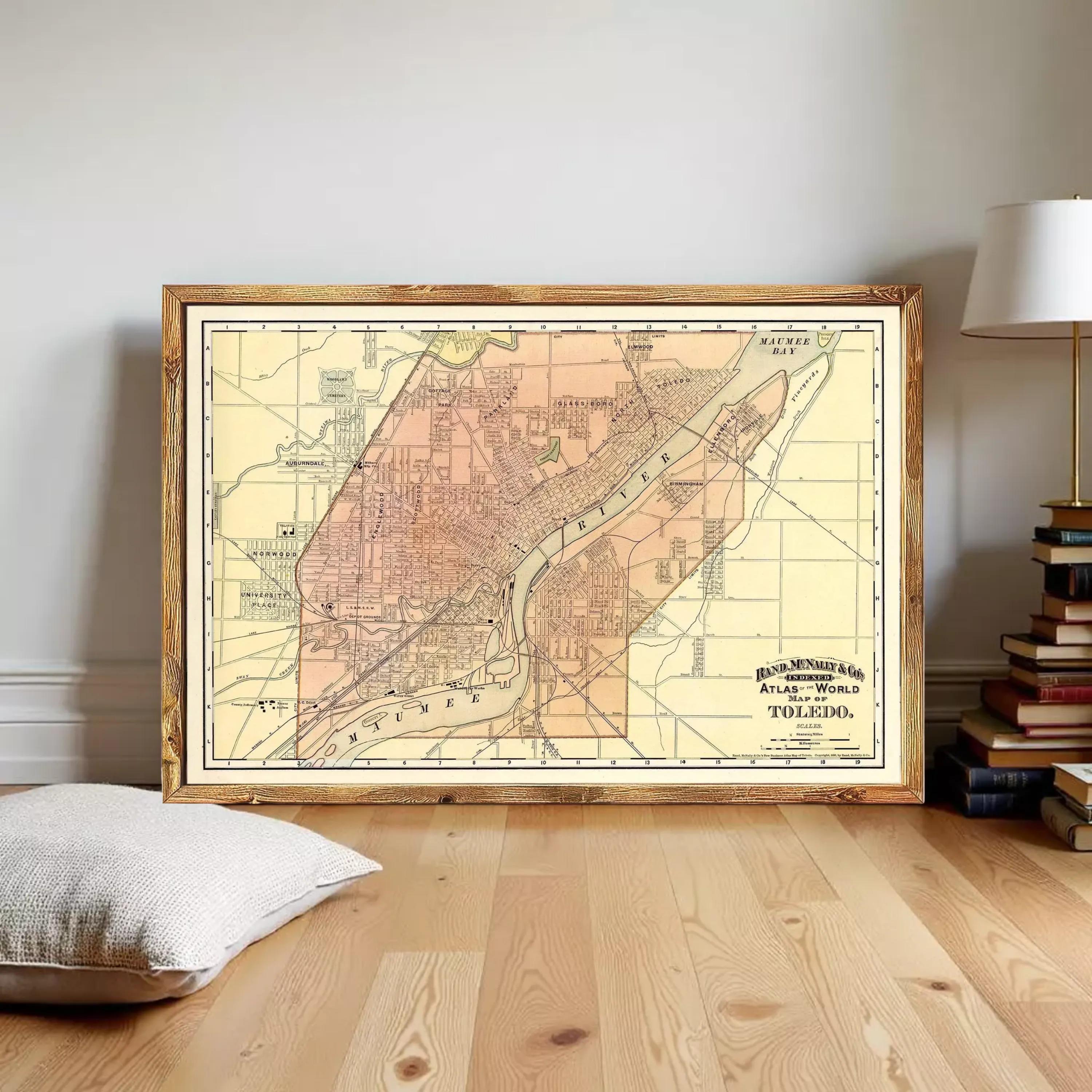 The image is a framed vintage map of a city, likely Toledo, Ohio, with a wooden border.