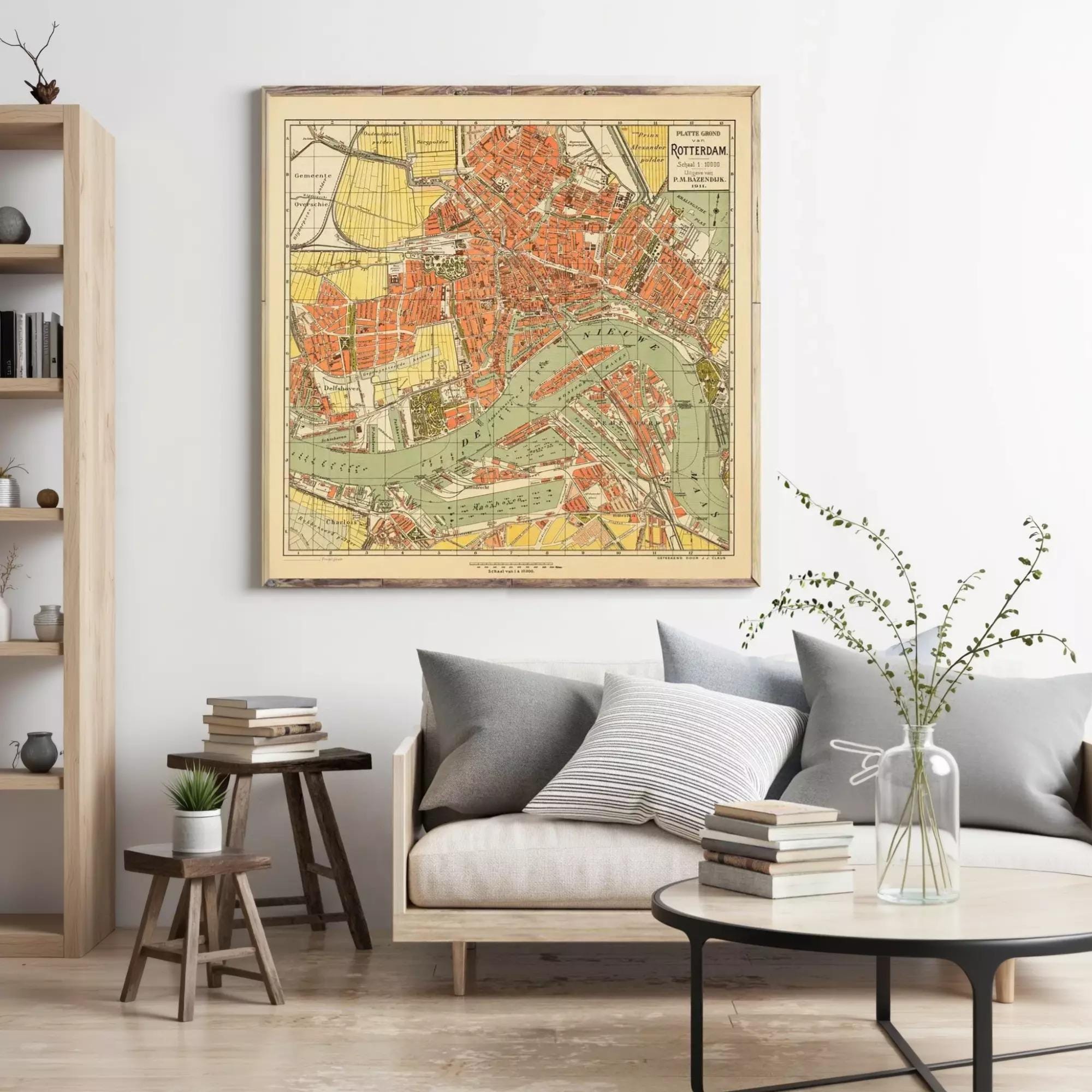 a large framed map of Rotterdam hanging on a wall in a living room setting.