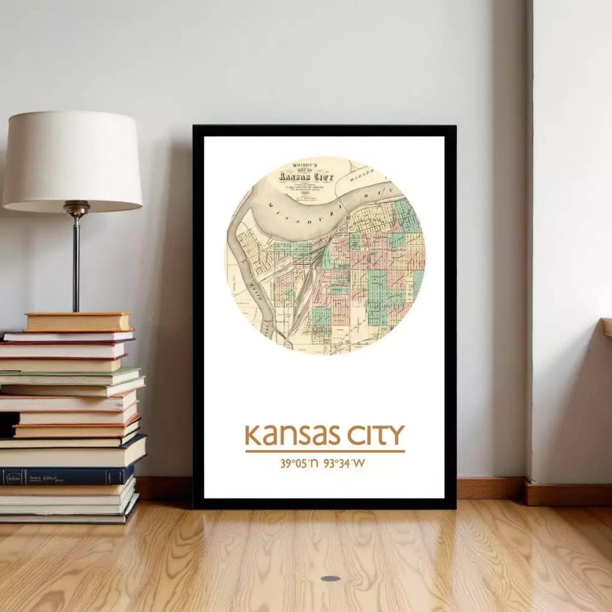 A framed map of Kansas City, with the city's location and surrounding area, is displayed on a wall next to a stack of books and a lamp.
