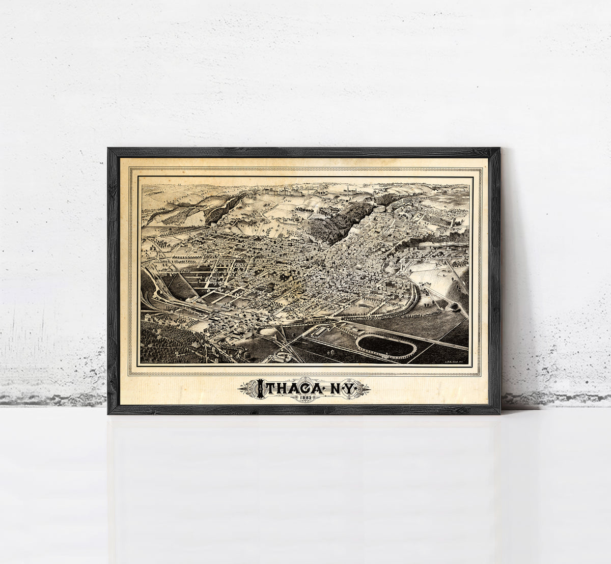 The image is a framed vintage map of Ithaca, New York, depicting the city's layout and surrounding areas.