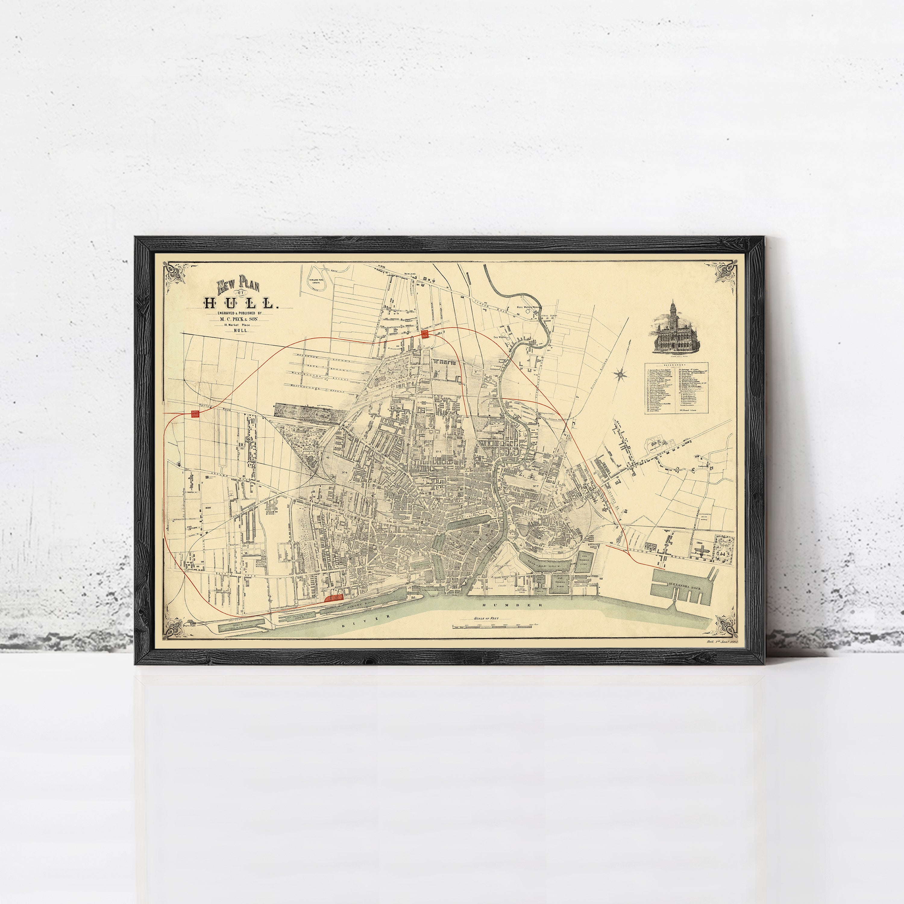 The image is a framed vintage map of a city, depicting streets, buildings, and other urban elements.