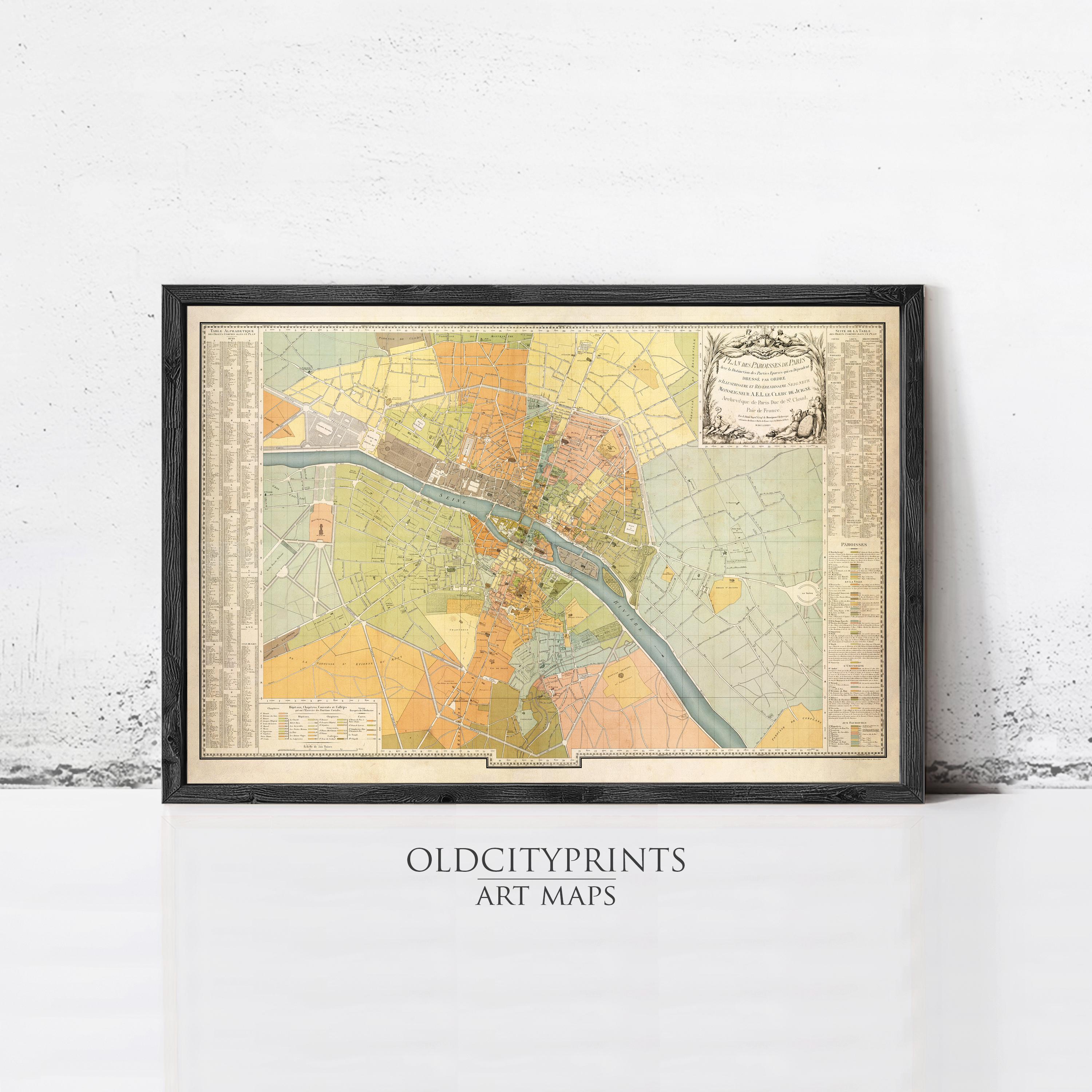 The image is a framed vintage map of a city, likely from the 19th century, displayed on a wall.