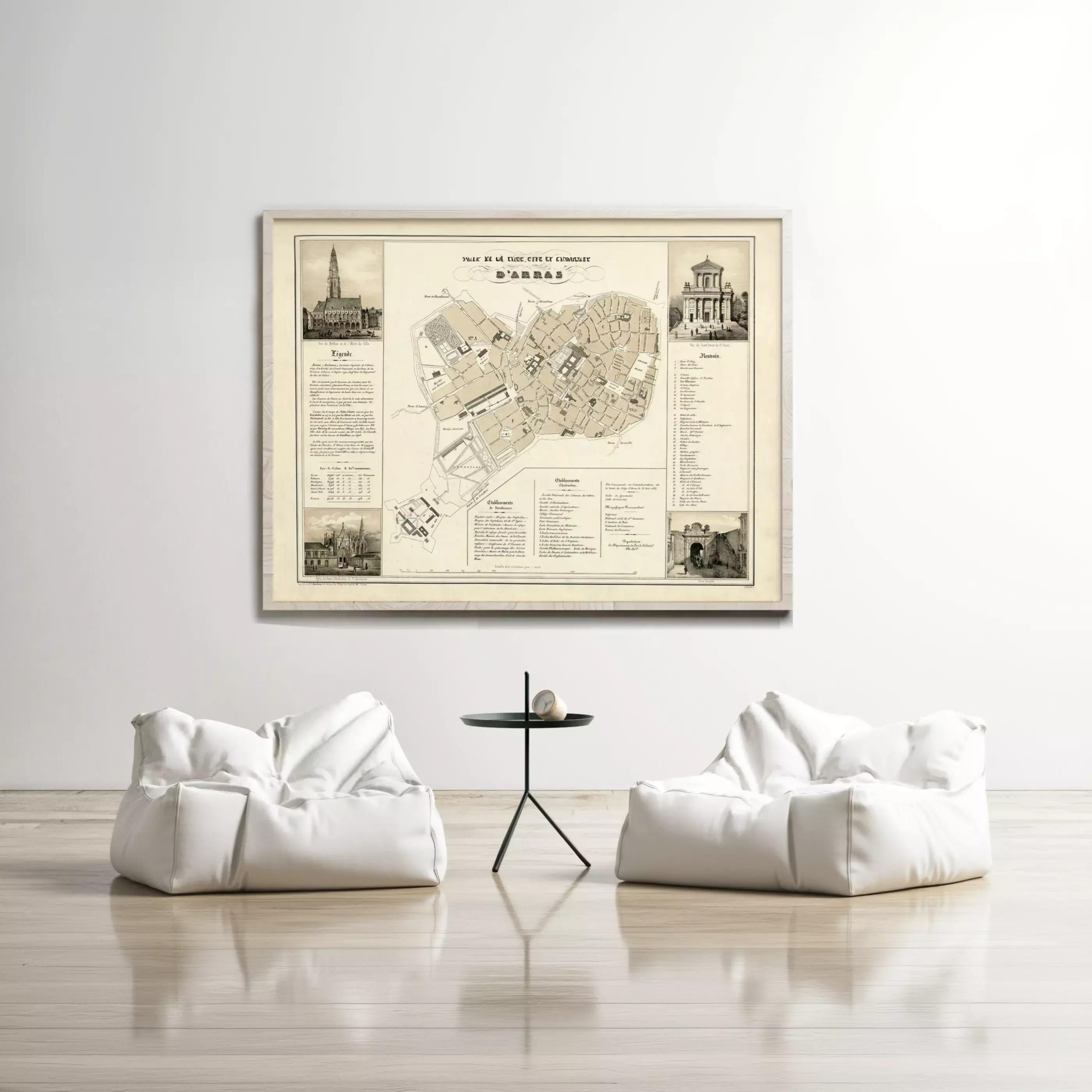 a large framed map of a city hanging on a wall, with two white bean bag chairs positioned in front of it.