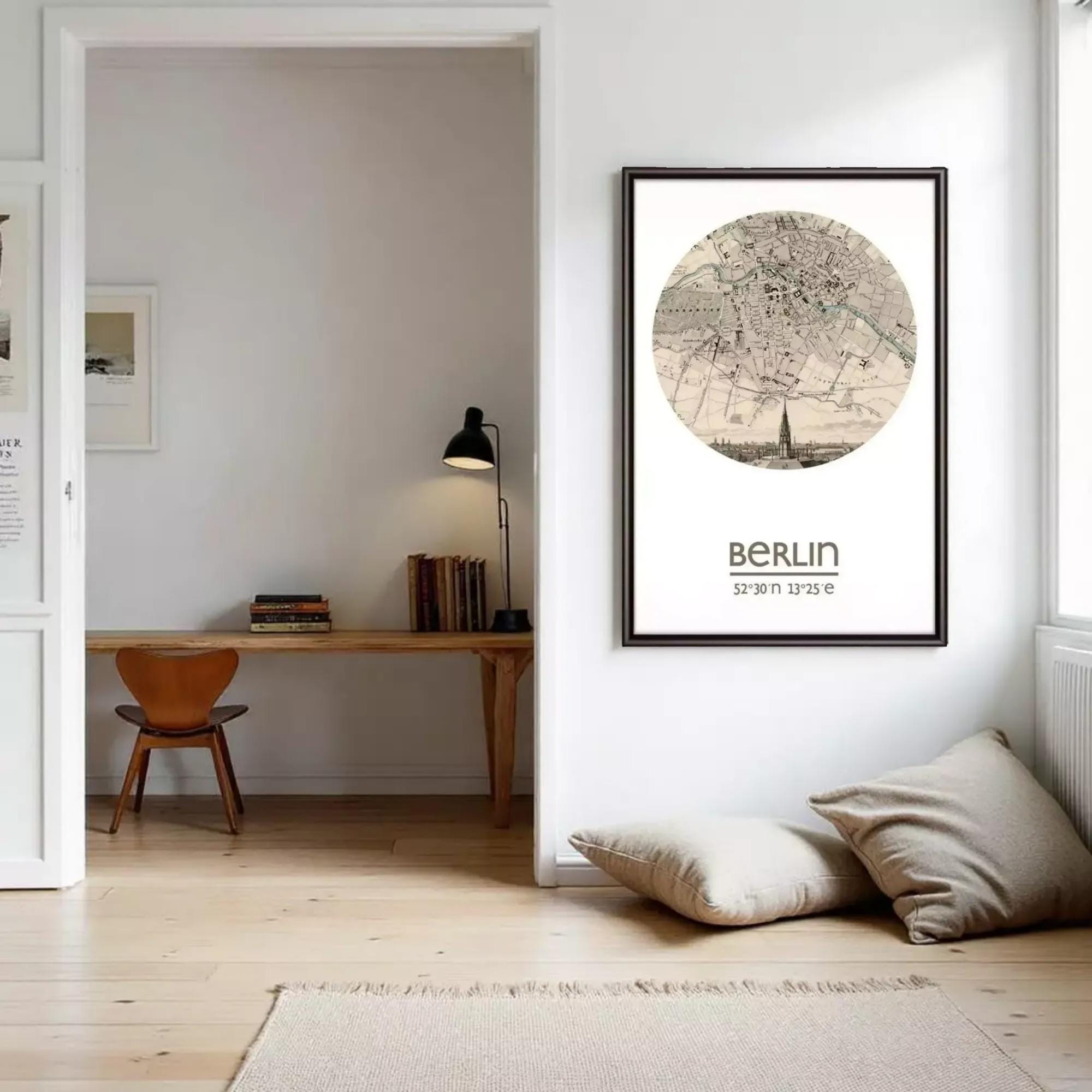 a cozy and well-organized living space with a desk, chair, and bookshelf. The room has a warm and inviting atmosphere, with a large circular map of Berlin hanging on the wall.