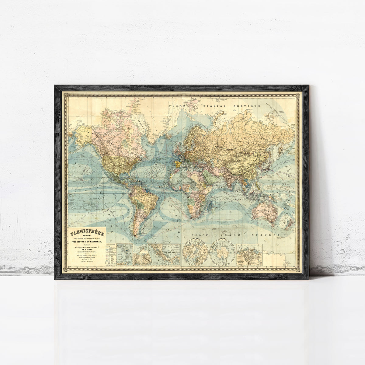 The image is a framed vintage map of the world, depicting the continents and oceans in a detailed and colorful manner.