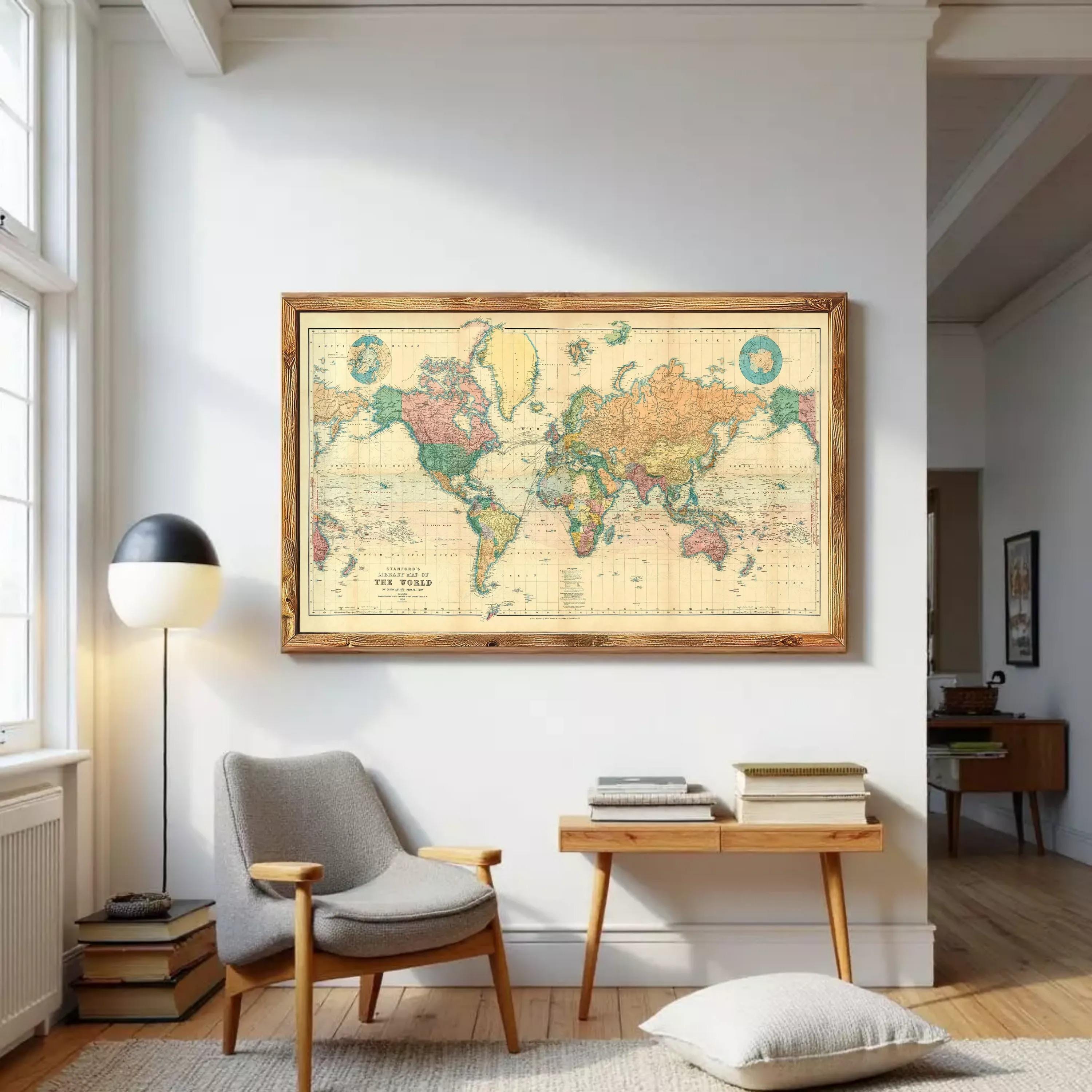 The image is a framed vintage world map with a wooden border, displayed on a white wall.