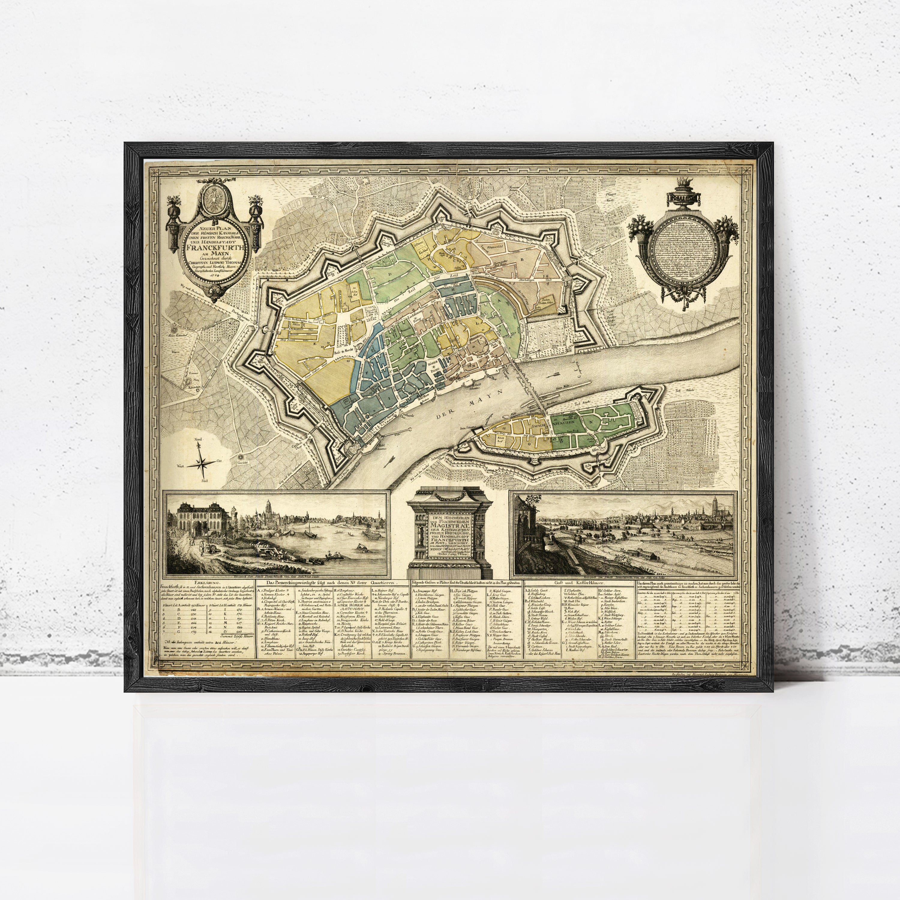 The image is a framed antique map of a city, depicting various landmarks and streets.