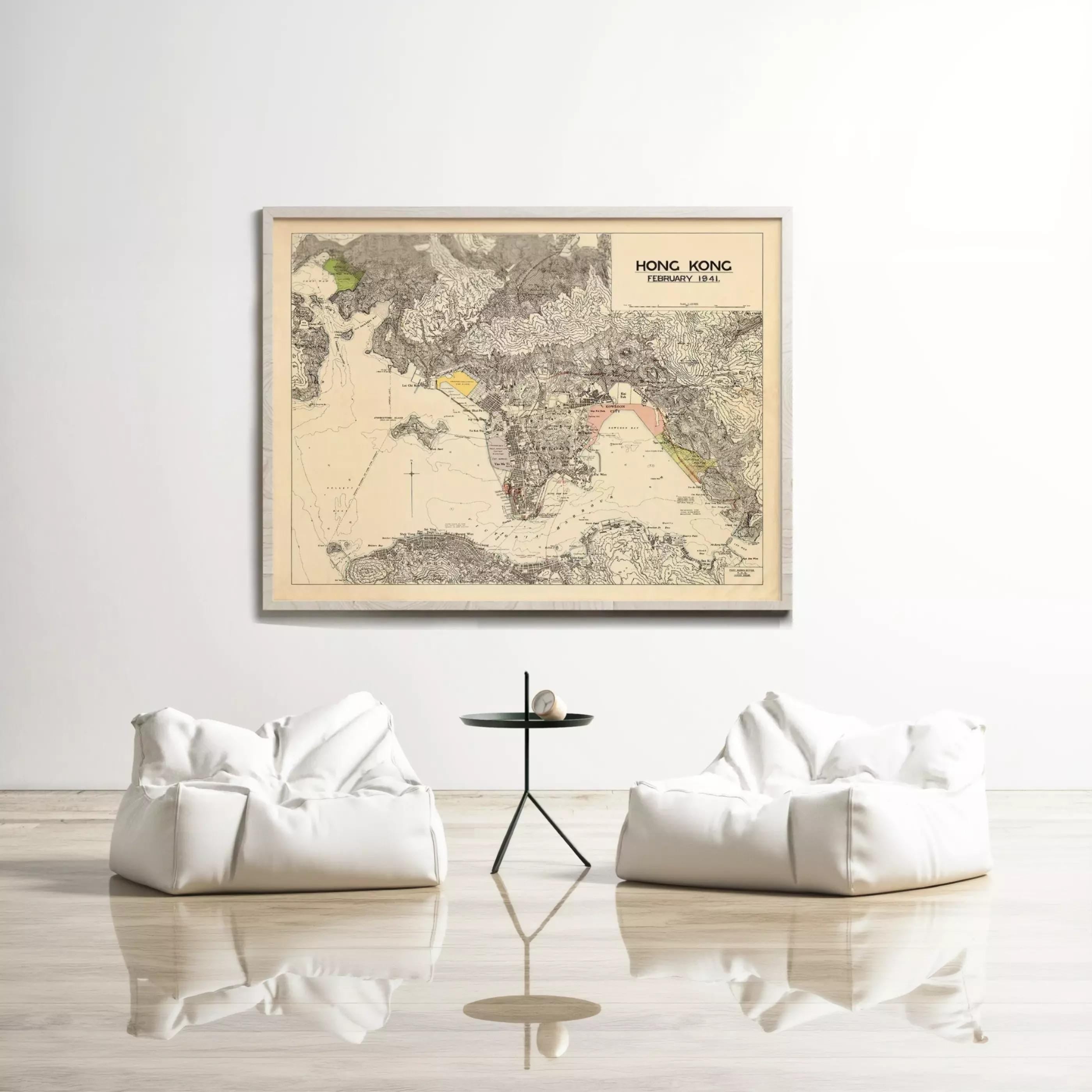 a large framed map of Hong Kong hanging on a white wall, with two white bean bag chairs positioned in front of it.
