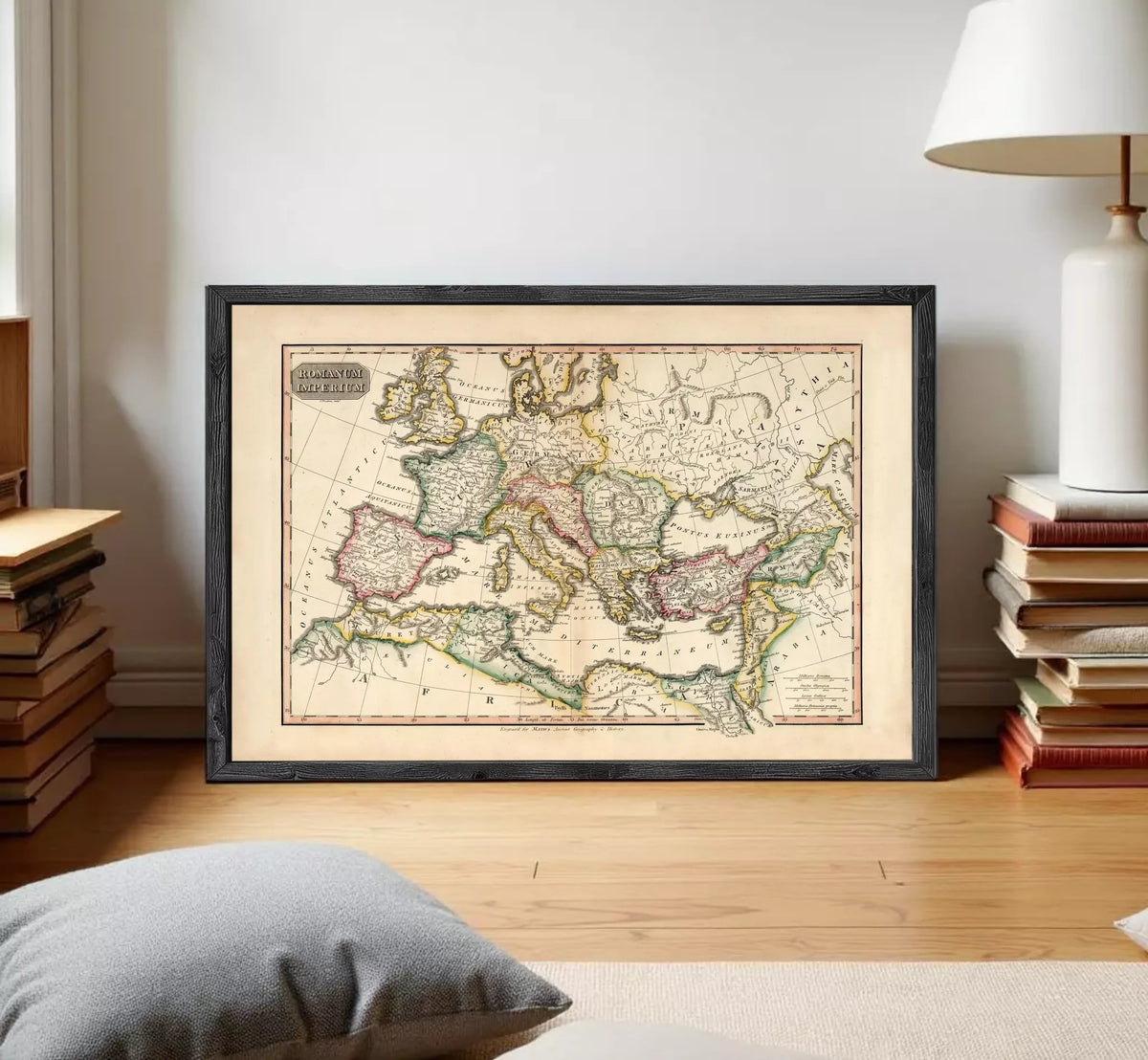 The image is a framed antique map of Europe and the Mediterranean region, displayed on a white wall.