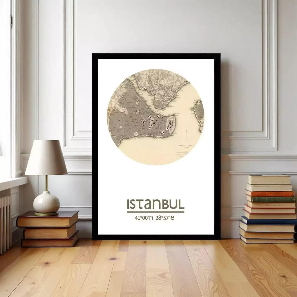 A framed map of Istanbul, Turkey, with the text "ISTANBUL 41:00 28:57" printed on it, is displayed on a wall in a room with a lamp and books.
