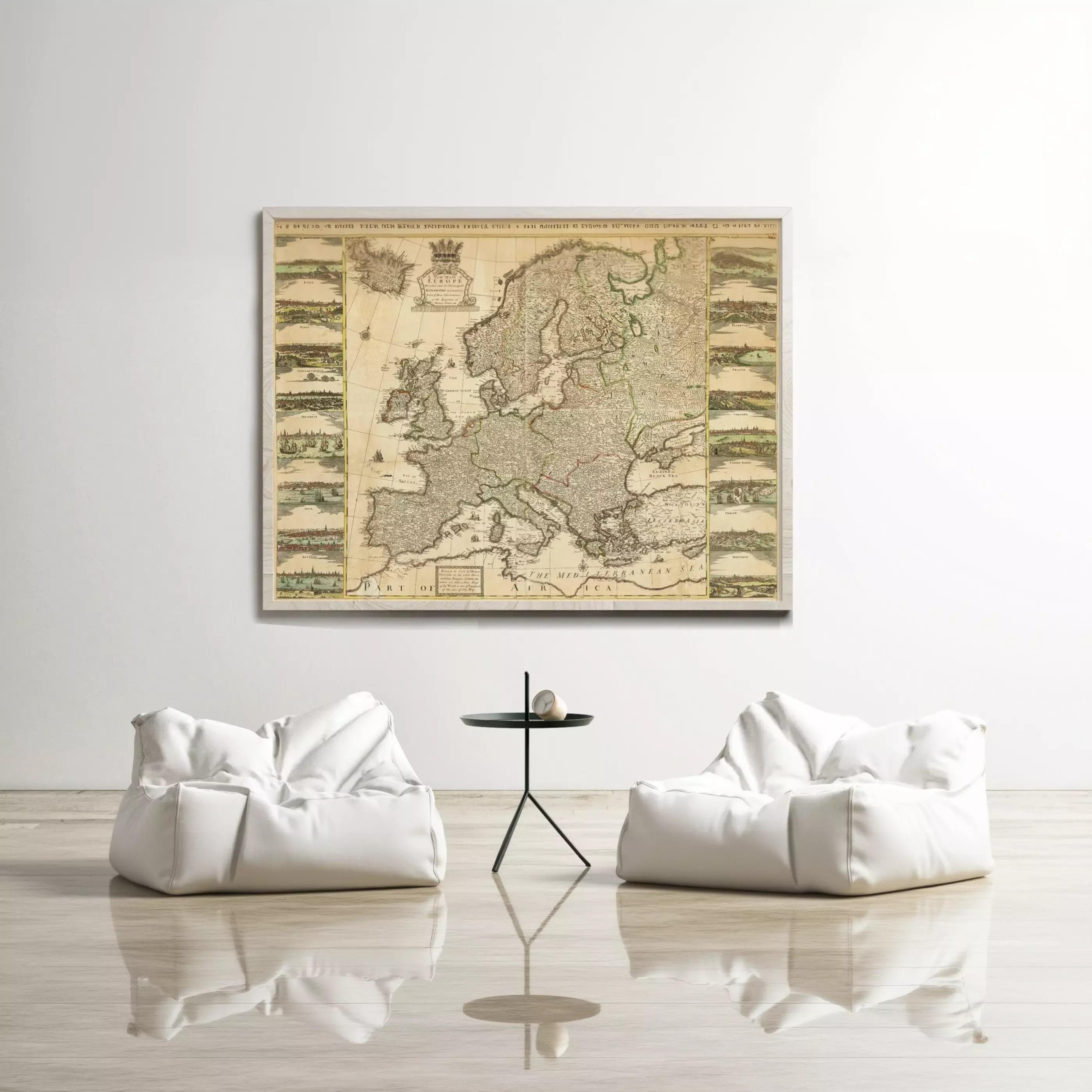 a large map of Europe displayed on a wall, with two white bean bag chairs positioned in front of it.