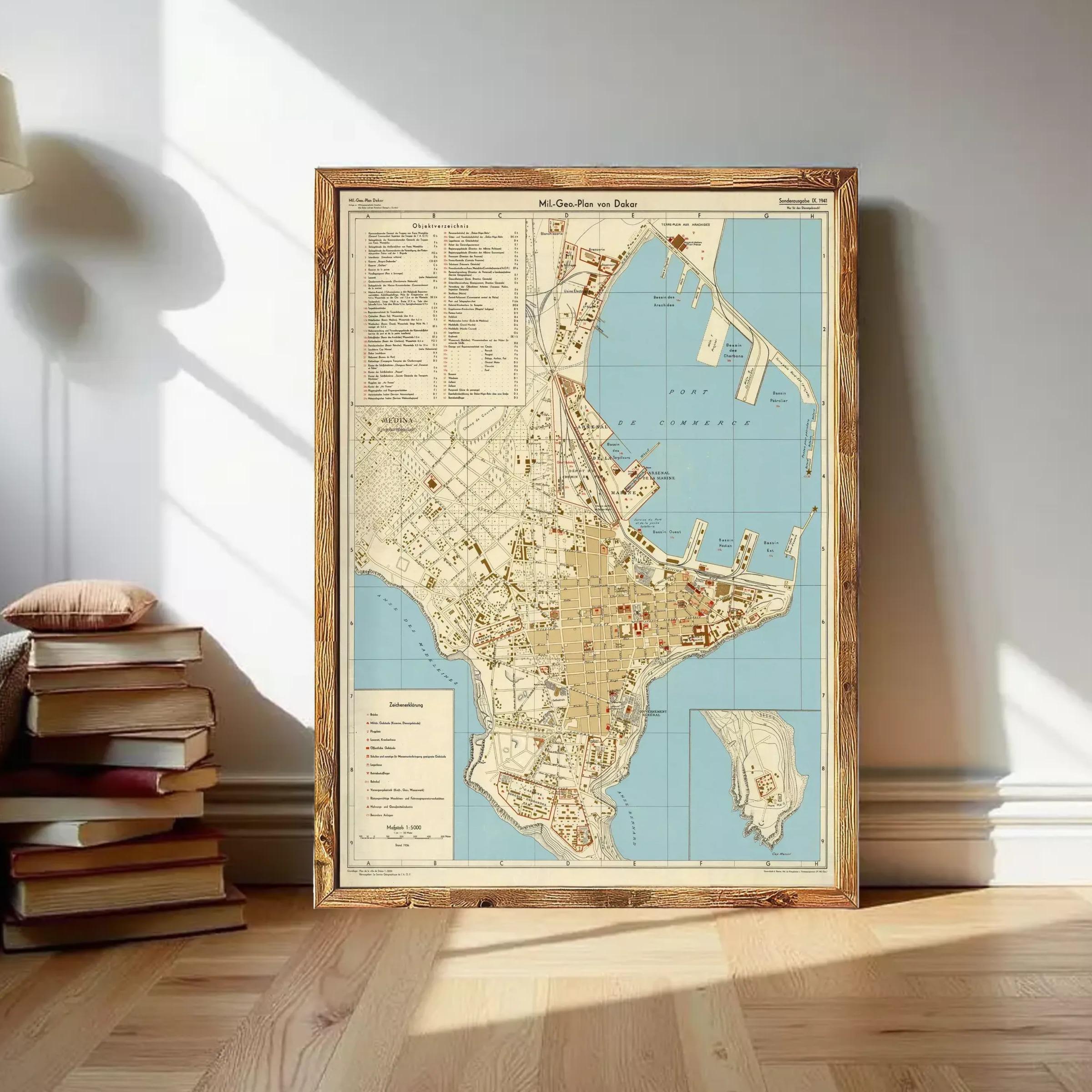 The image is a framed vintage map of a city, likely from the 19th century, displayed on a wall.