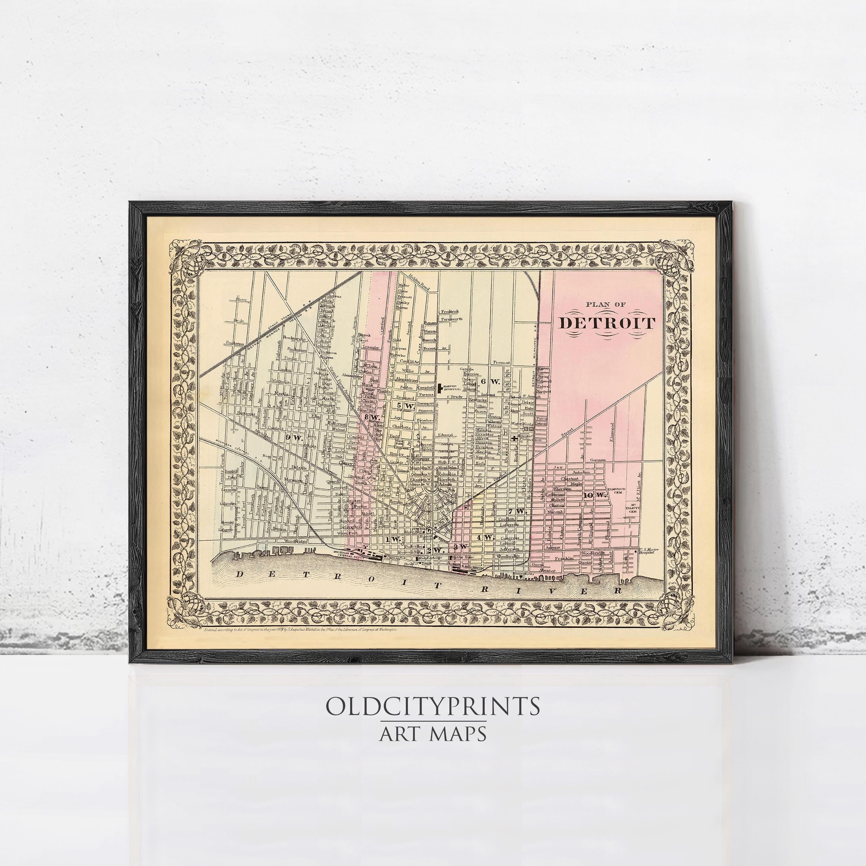 The image is a framed vintage map of Detroit, Michigan, depicting the city's streets and landmarks.