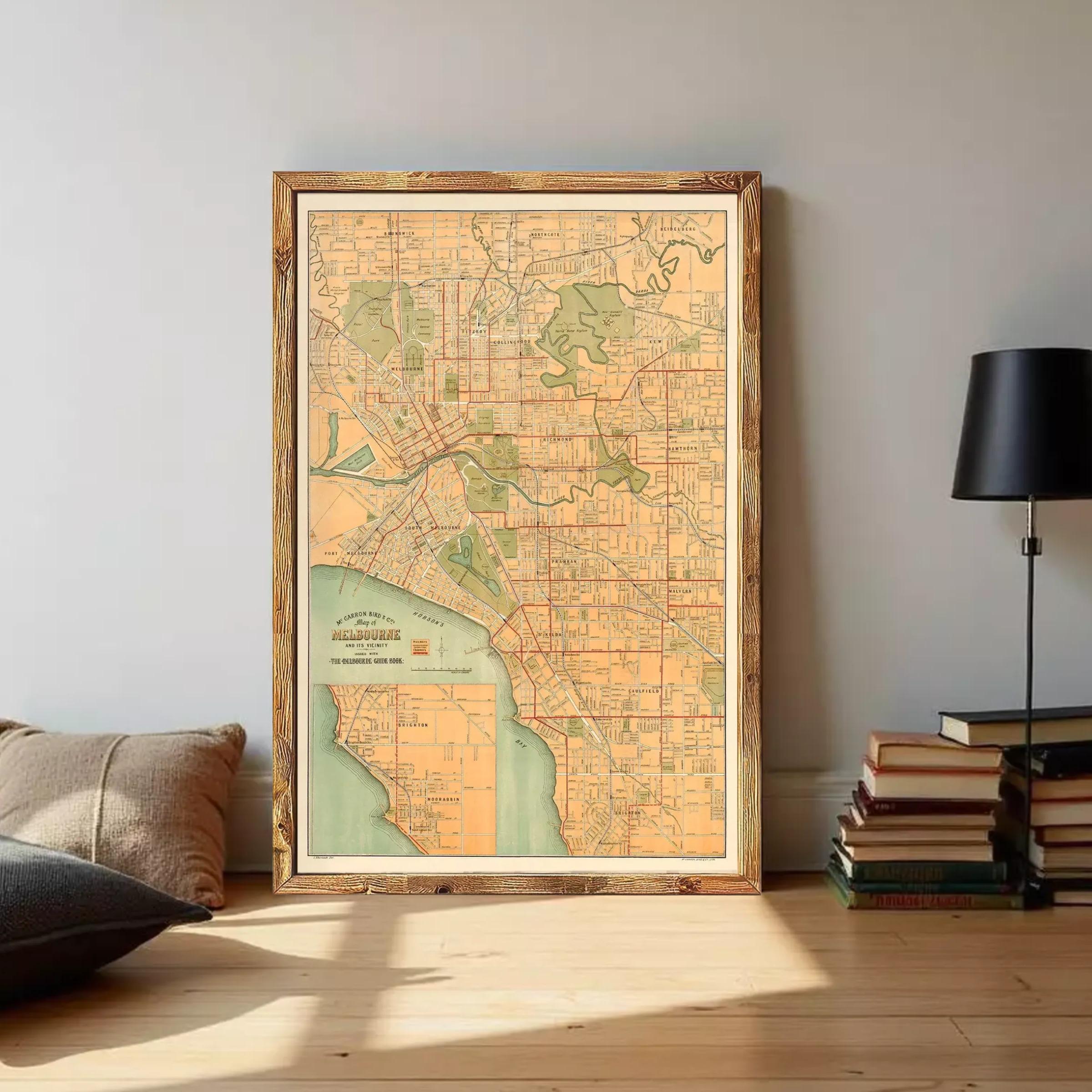 The image is a framed vintage map of Melbourne, Australia, depicting the city's streets and surrounding areas.
