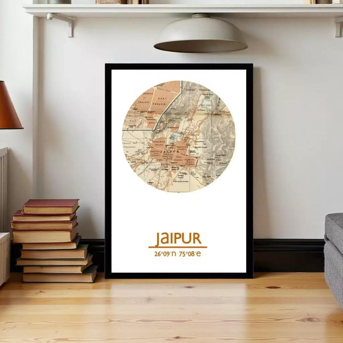 A framed map of Jaipur, India, with the city's name prominently displayed. The map is surrounded by a border, and the image is set against a white wall.