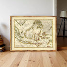 a large, framed map of the world, likely from the 17th century, displayed on a wooden floor in a room.