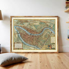 The image is a framed antique map of a city, likely from the 16th century, depicting a detailed layout of the city with streets, buildings, and other landmarks.