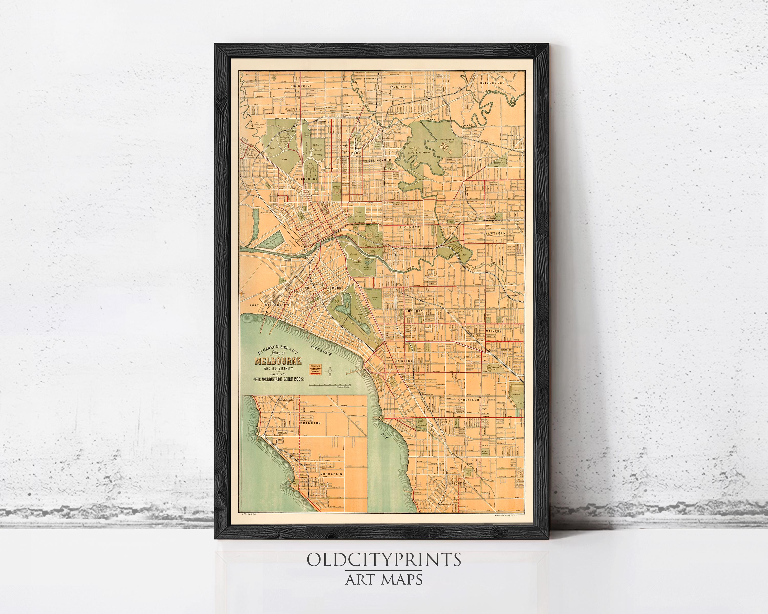 The image is a framed vintage map of Melbourne, Australia, depicting the city's streets and surrounding areas.