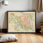 The image is a framed vintage map of Hanoi, Vietnam, depicting the city's streets, landmarks, and surrounding areas.