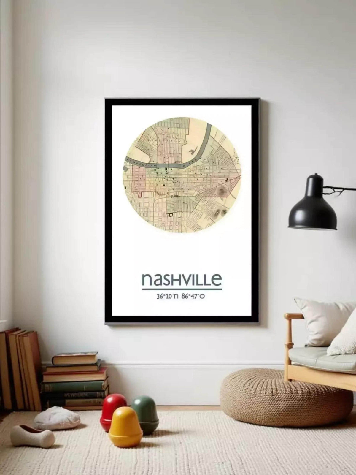 a framed map of Nashville, with a lamp and a stack of books in the foreground.