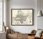 The image is a framed vintage map of a city, likely from the 19th century, depicting the layout and geographical features of the area.