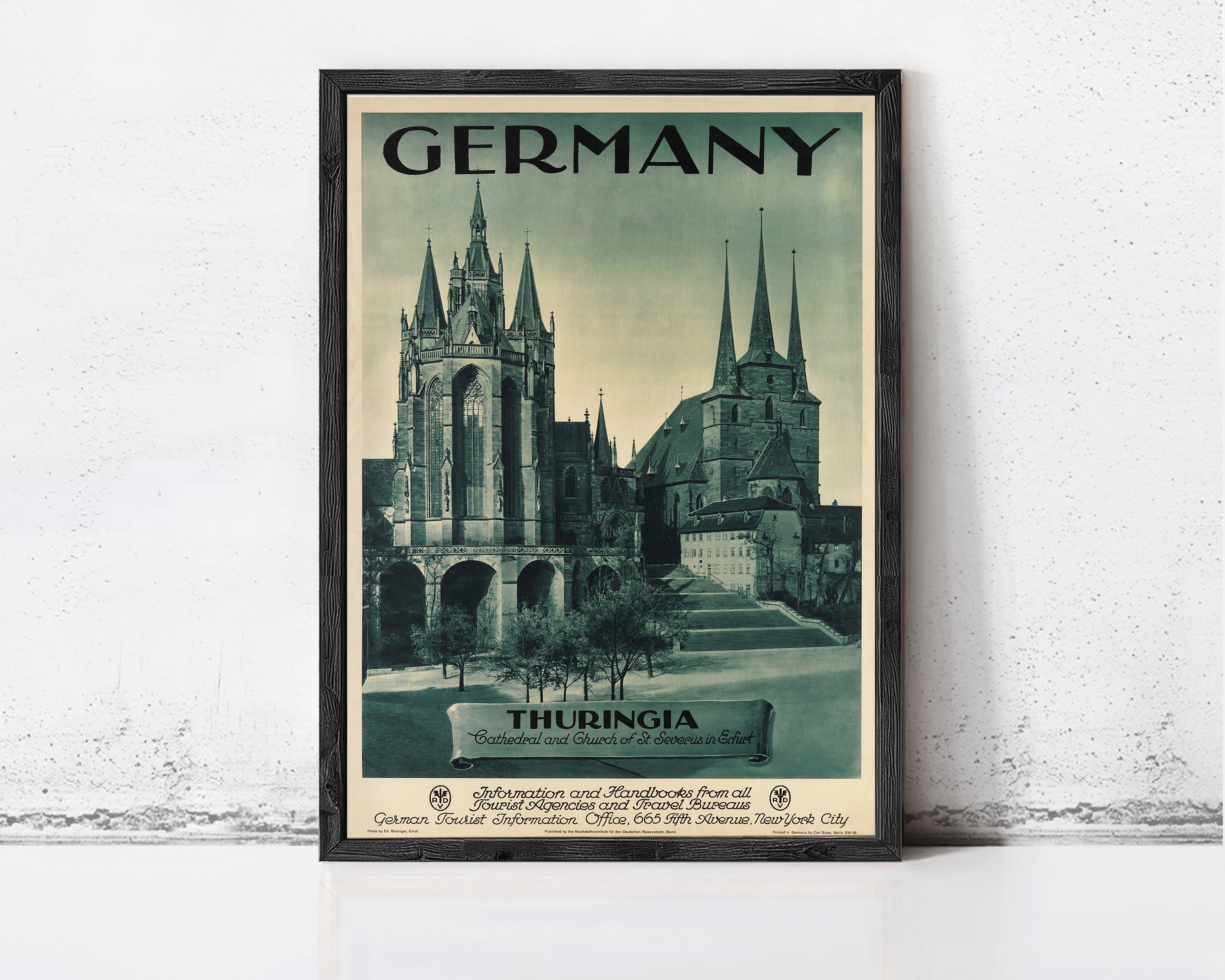 The image is a framed vintage travel poster advertising Germany, featuring the spires of the Thuringian Cathedral and the Church of St. Stephen in Thuringia.