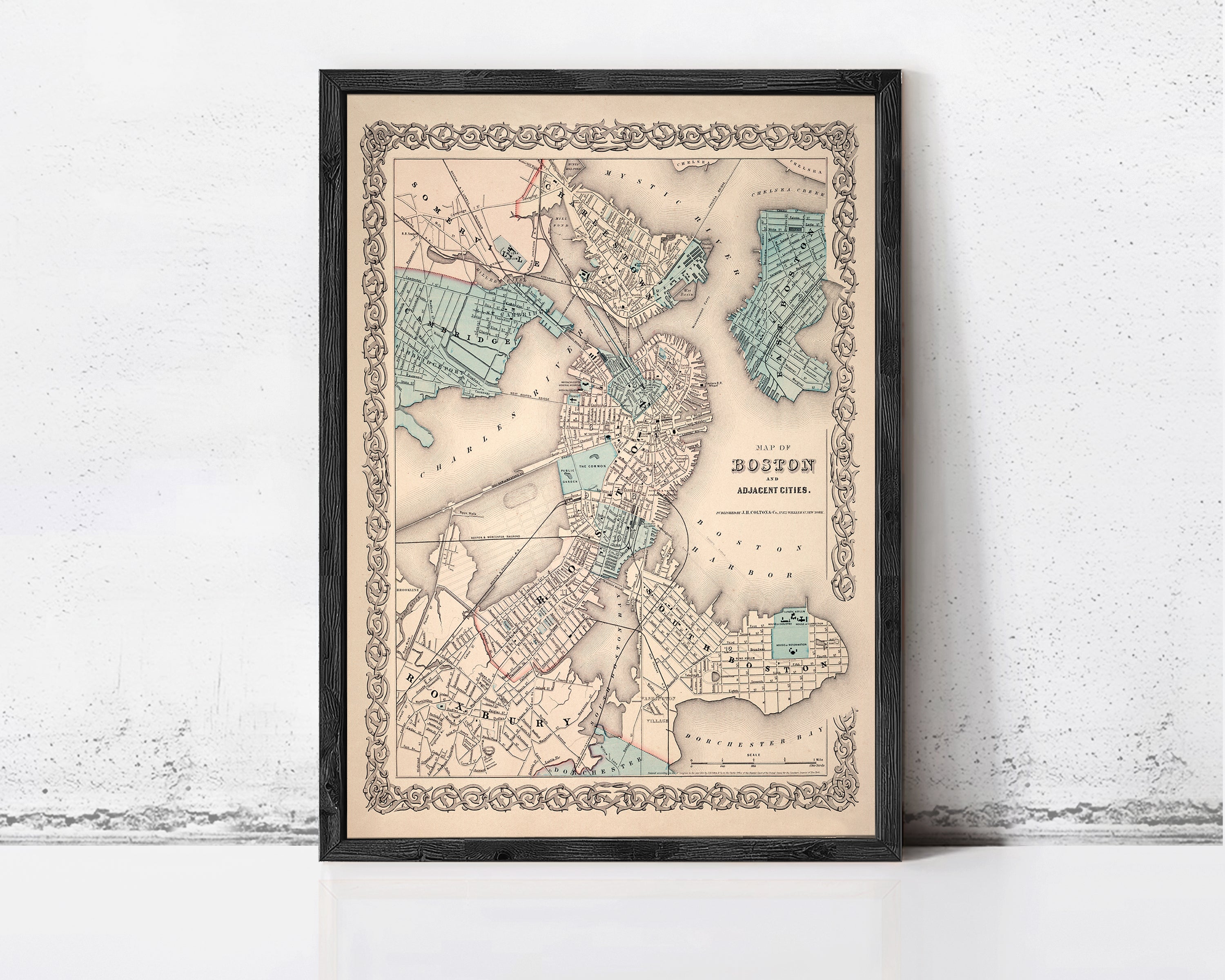 The image is a framed vintage map of Boston, Massachusetts, with a detailed and intricate design.