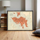 The image is a framed vintage map of Hong Kong, depicting the island and surrounding areas in a detailed and colorful manner.