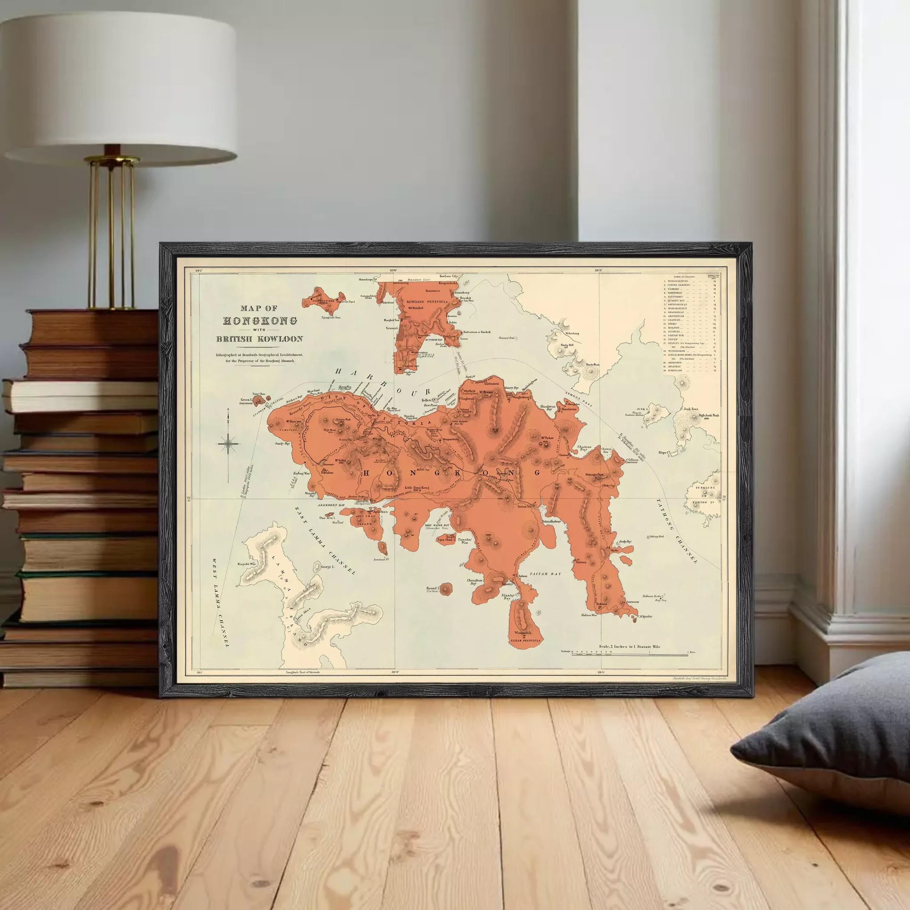 The image is a framed vintage map of Hong Kong, depicting the island and surrounding areas in a detailed and colorful manner.