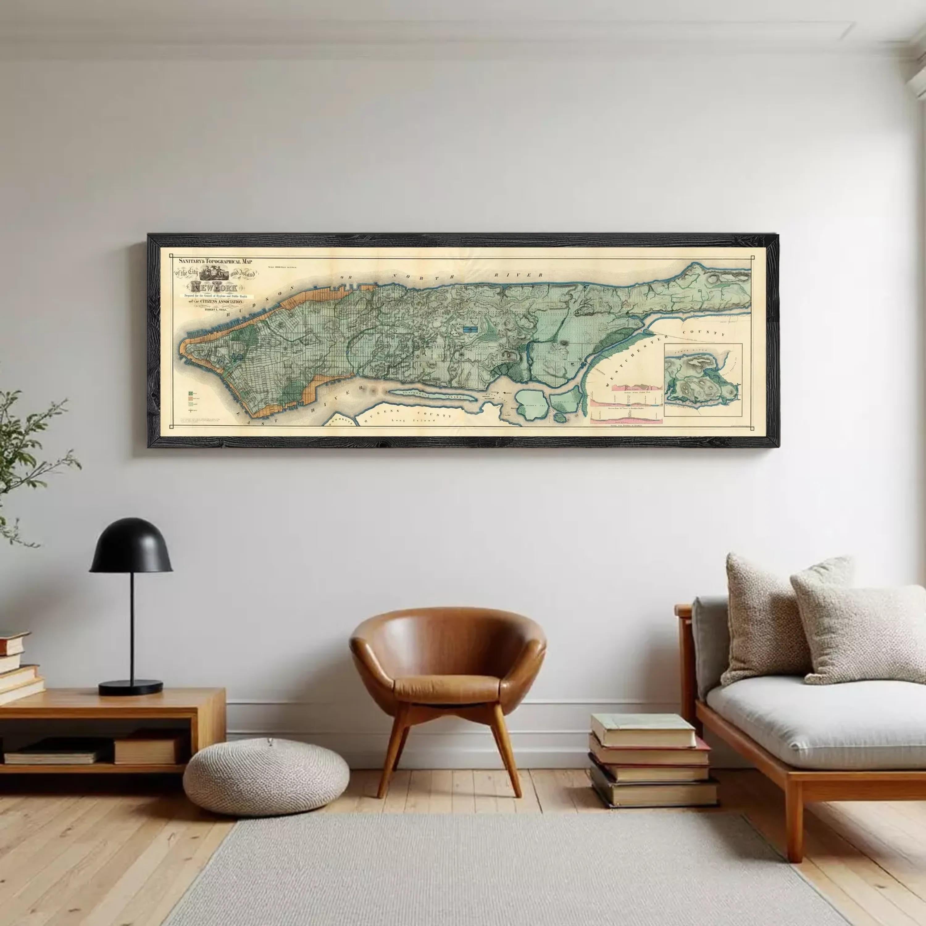 A framed map of New York City, depicting the city's streets and neighborhoods, is displayed against a white wall.