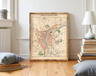 The image is a framed vintage map of a city, likely Paris, with various landmarks and streets depicted.