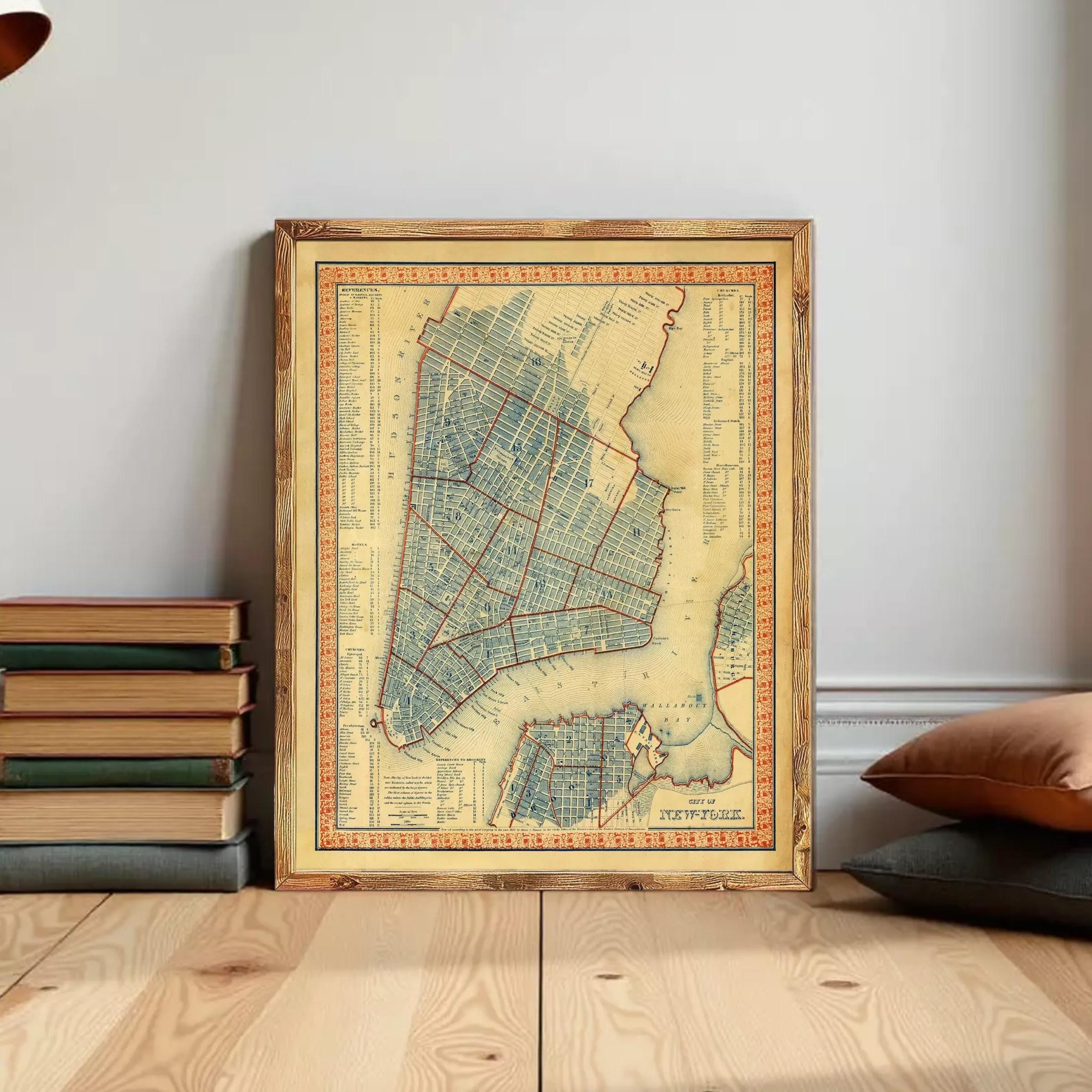 The image is a framed vintage map of New York City, depicting the city's streets and neighborhoods in a detailed and colorful manner.