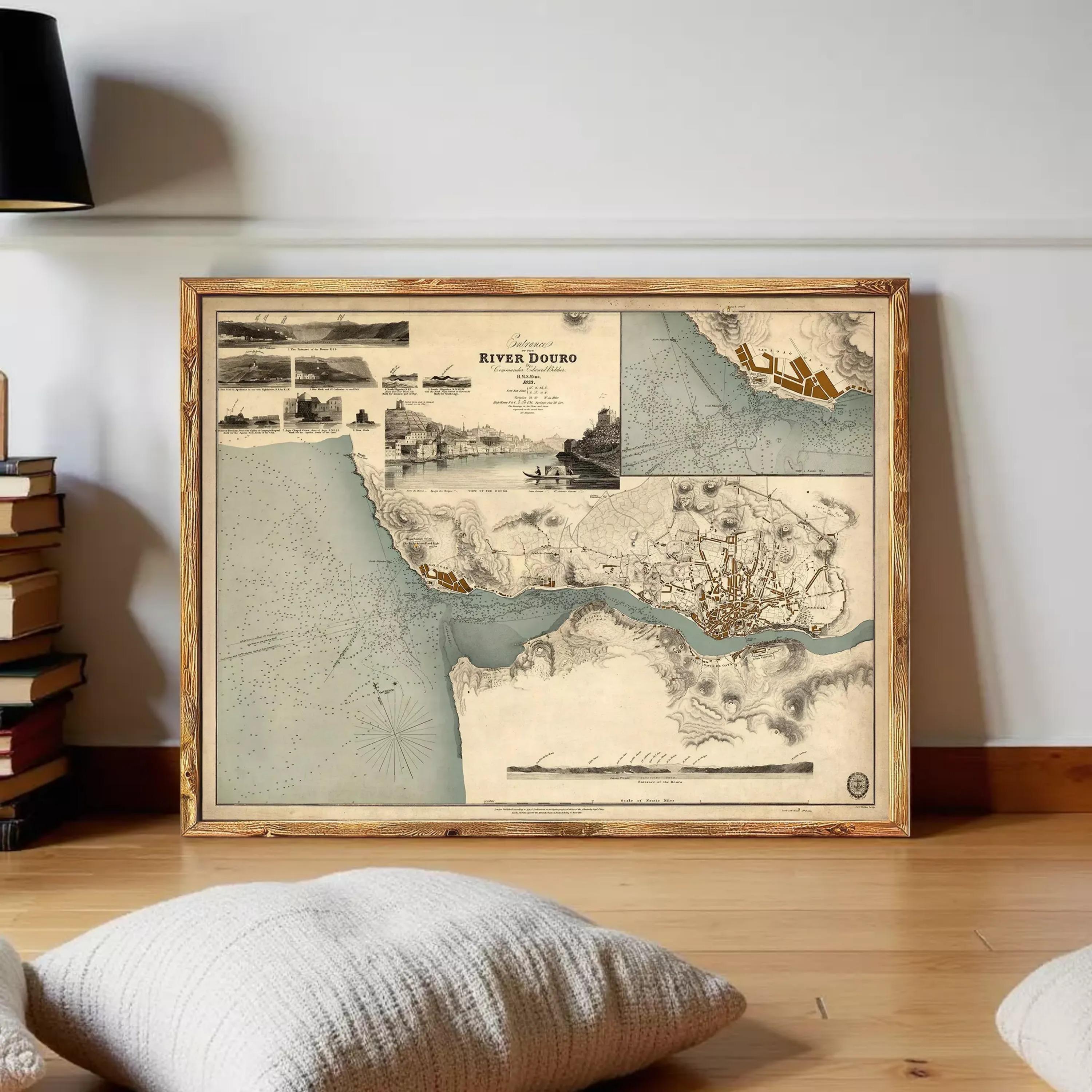 a framed vintage map of the River Duro, which is a river located in the United Kingdom. The map is displayed on a wooden floor, with a stack of books and a pillow visible in the foreground.
