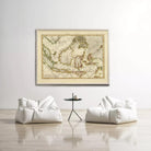 a large framed map of the world hanging on a white wall, with two white bean bag chairs positioned in front of it.