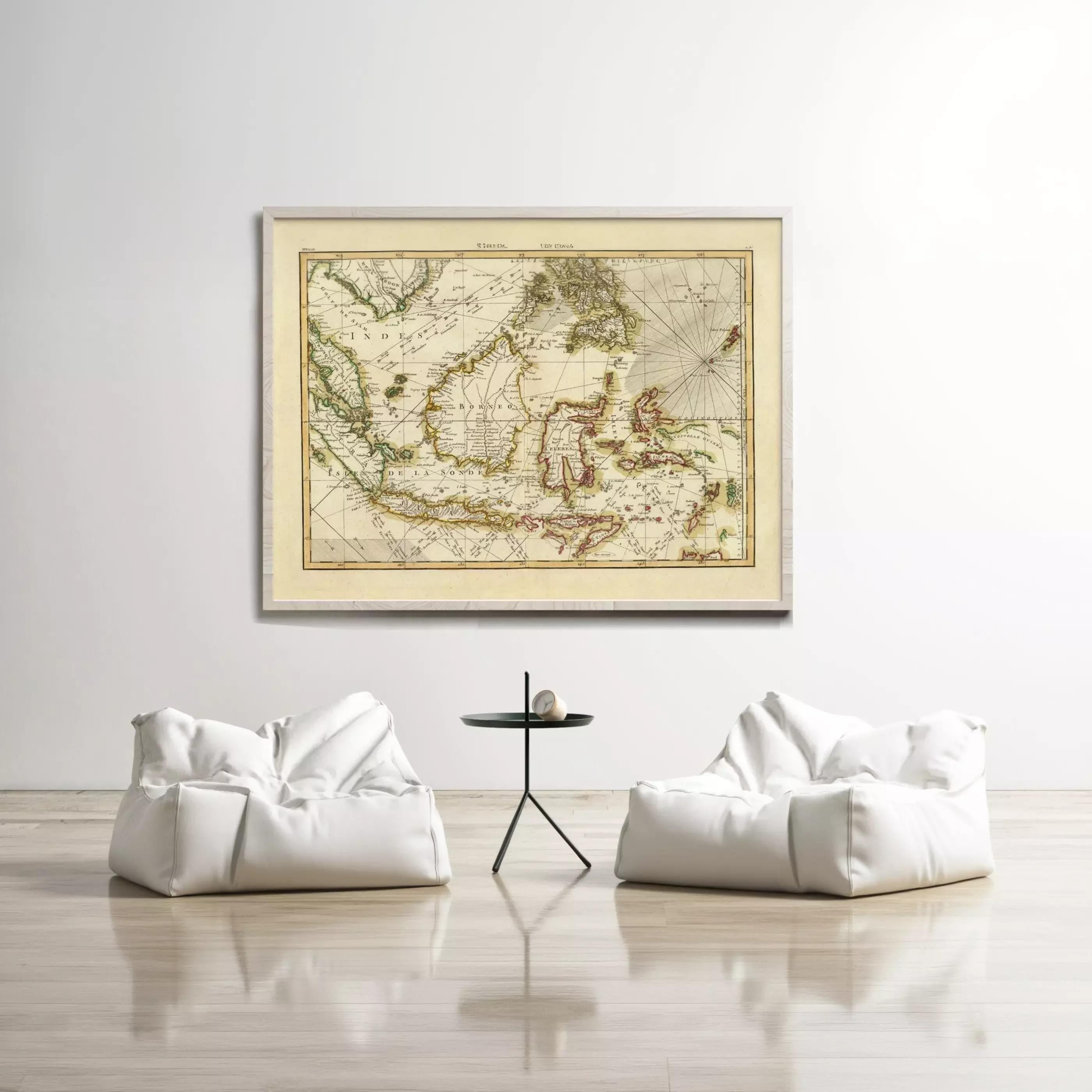 a large framed map of the world hanging on a white wall, with two white bean bag chairs positioned in front of it.