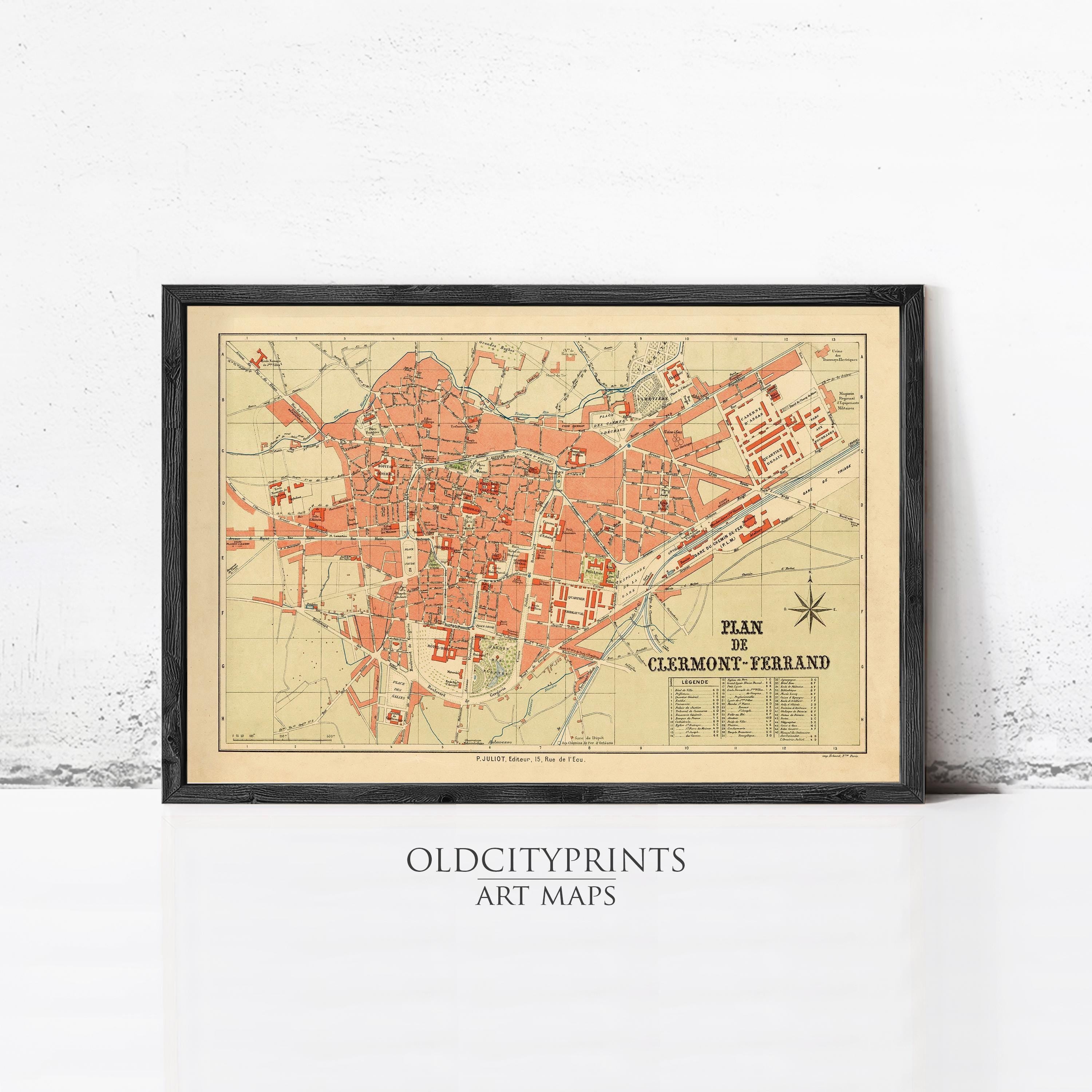 The image is a framed vintage map of a city, likely Clemont-Ferrand, with a black border and a beige background.