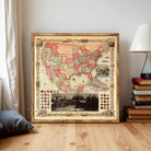 The image is a framed vintage map of the United States, with a black and white photograph of a group of people in the bottom right corner.