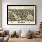 a large framed map of Pittsburgh, Pennsylvania, hanging on a wall in a living room setting.