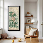 a living room with a large framed map of Banyai hanging on the wall, a wooden side table with a lamp, and a chair. There are also some books and a teddy bear on the floor.
