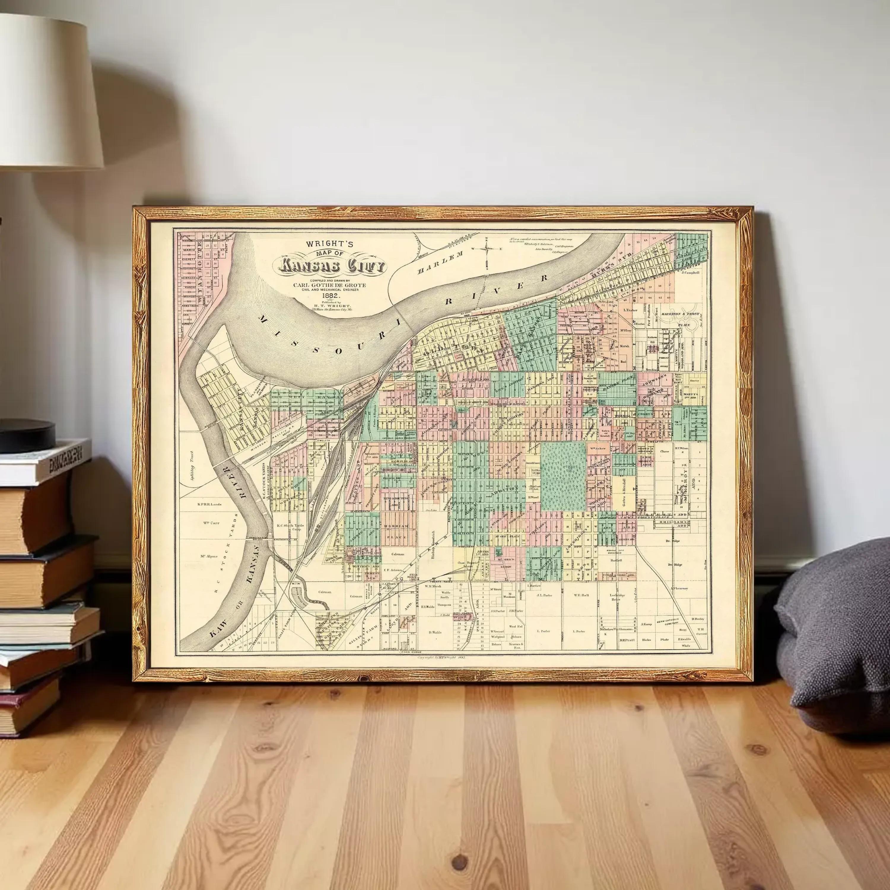 The image is a framed vintage map of the city of Kansas City, Missouri, with a detailed layout of streets, neighborhoods, and bodies of water.