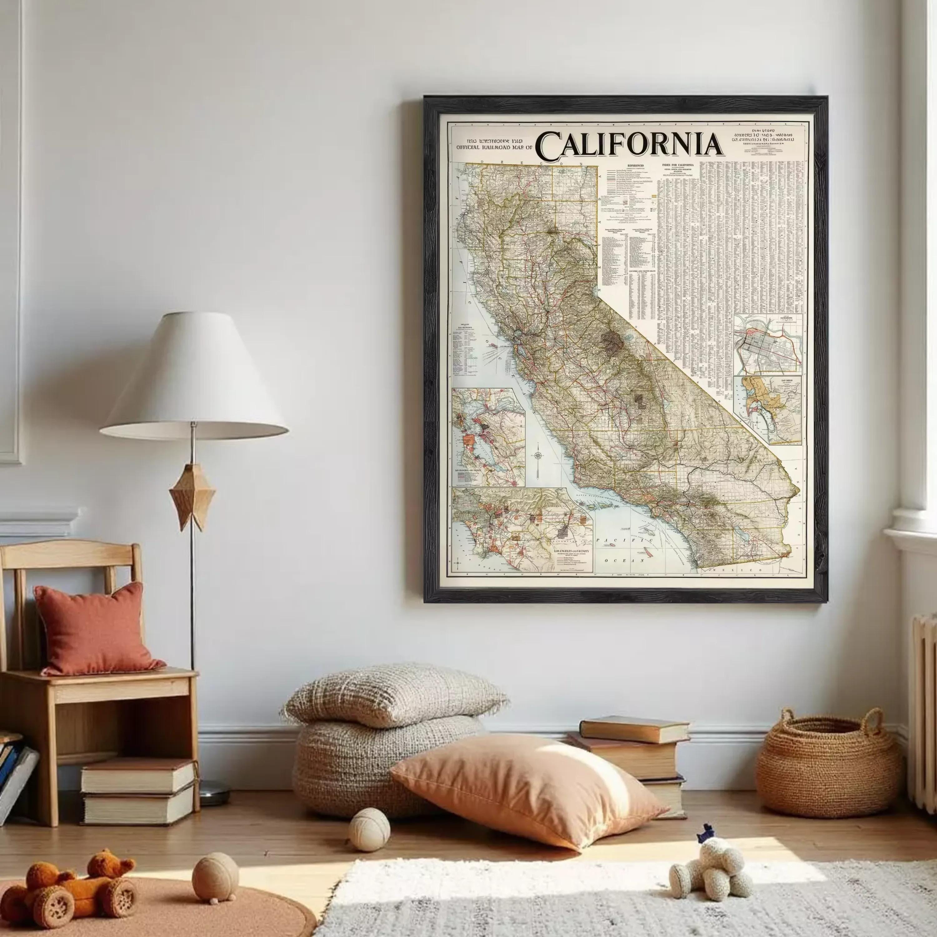 a large framed map of California hanging on a wall in a room with a wooden floor, a lamp, and some books and toys.