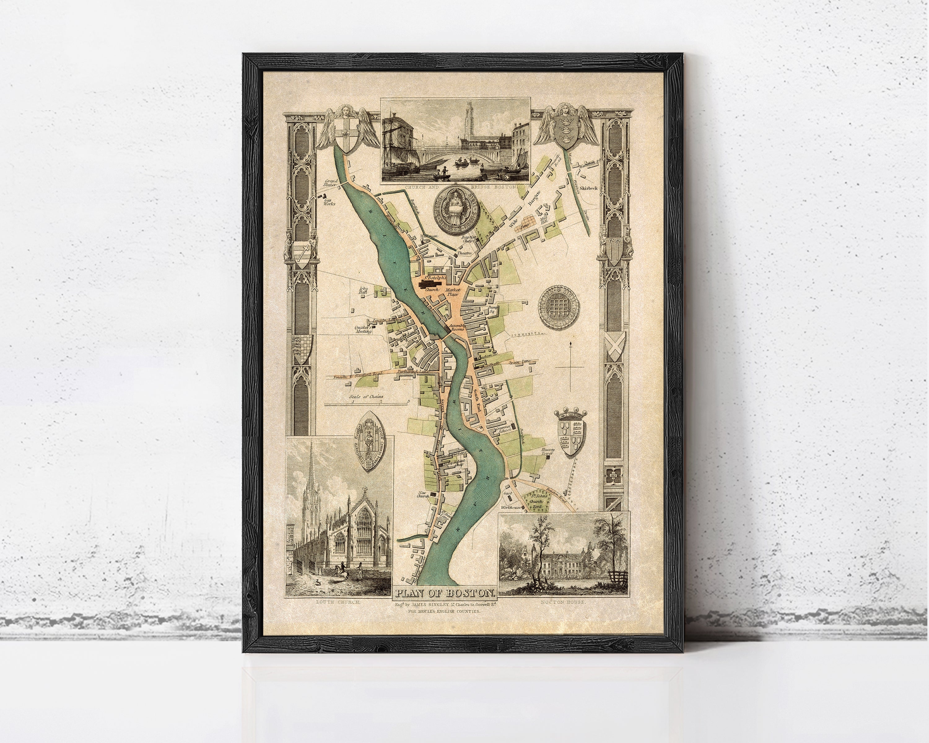 The image is a framed vintage map of a city, depicting various landmarks and streets.