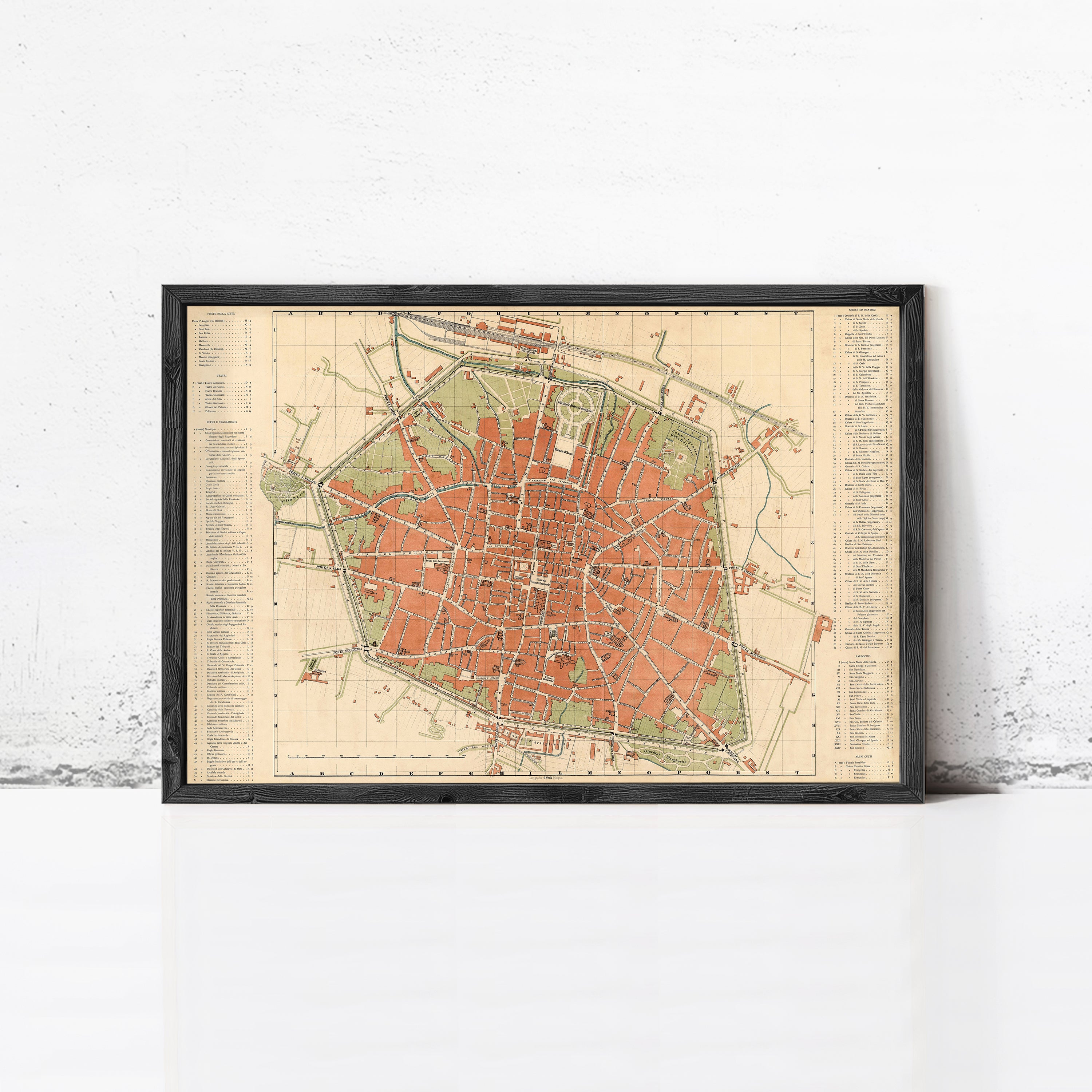 The image is a framed vintage map of a city, depicting a detailed layout of streets, buildings, and other urban features.