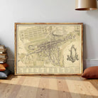 The image is a framed historical map of a city, likely from the 18th century, depicting a detailed layout of the streets, buildings, and surrounding areas.