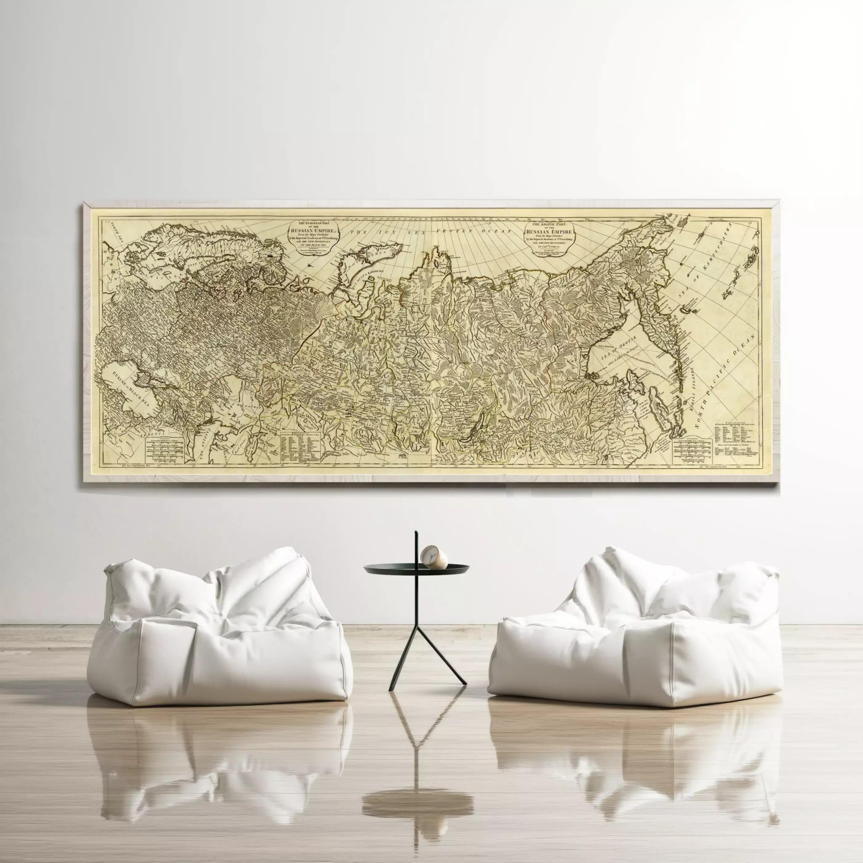 a large, antique map of the world displayed on the wall, with two white bean bag chairs positioned in front of it.