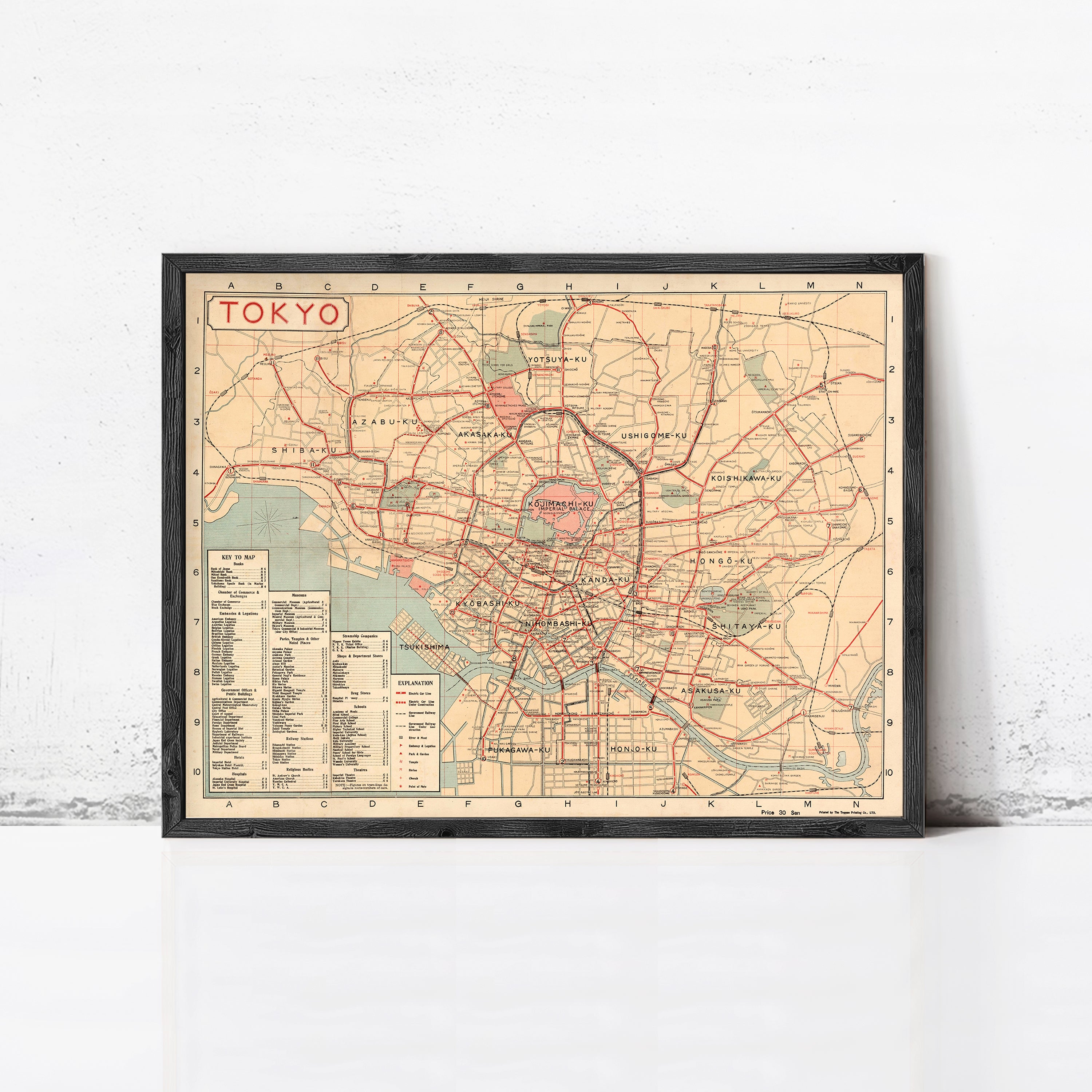 The image is a framed vintage map of Tokyo, Japan, depicting the city's streets and landmarks.