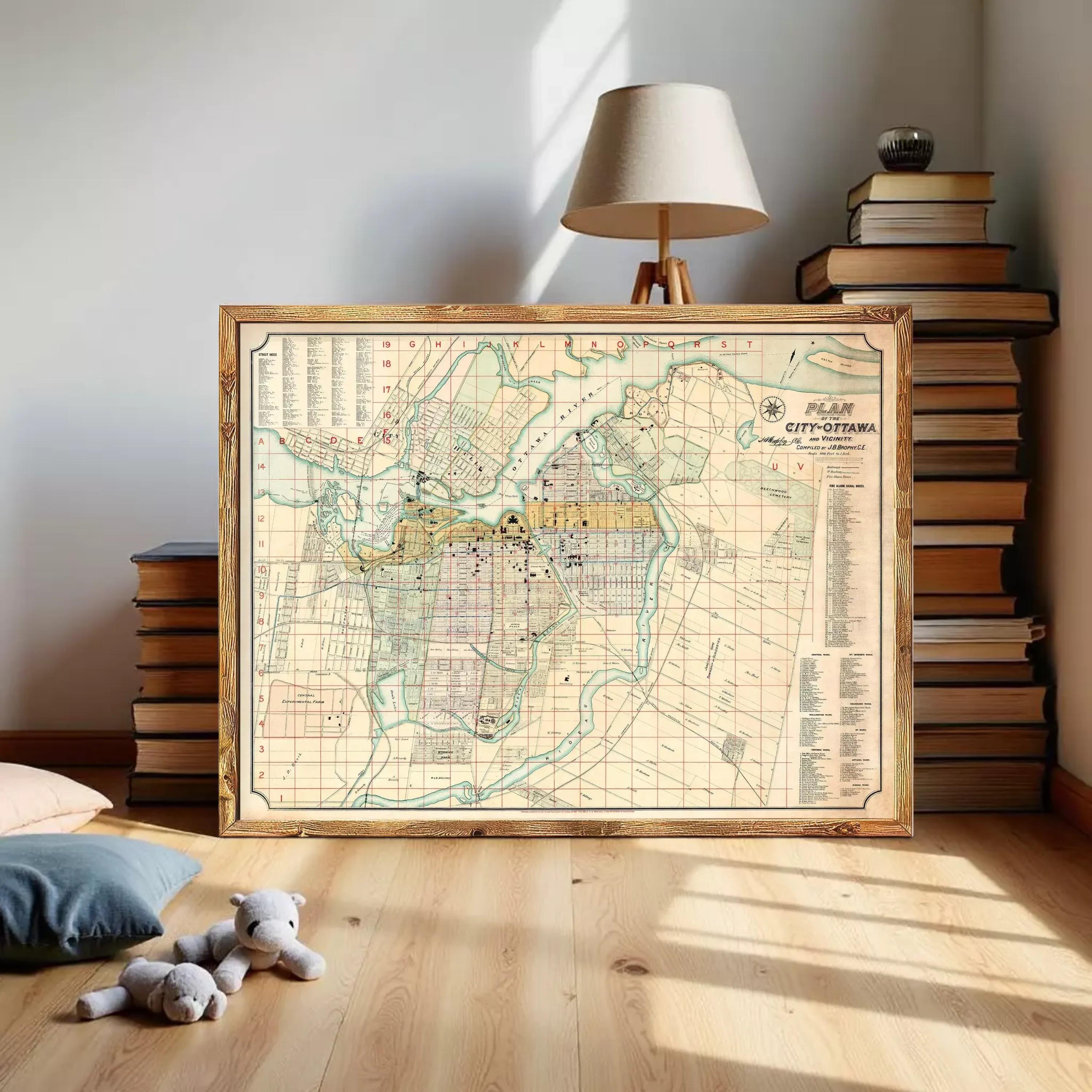a large framed map of a city, with a lamp and stacks of books in the background.